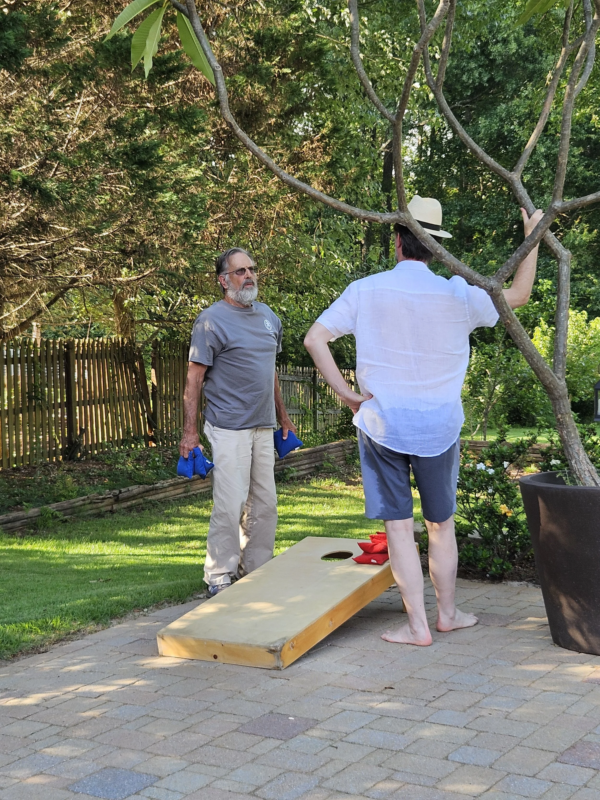 Patrick and David arguing over how best to toss beanbags.
