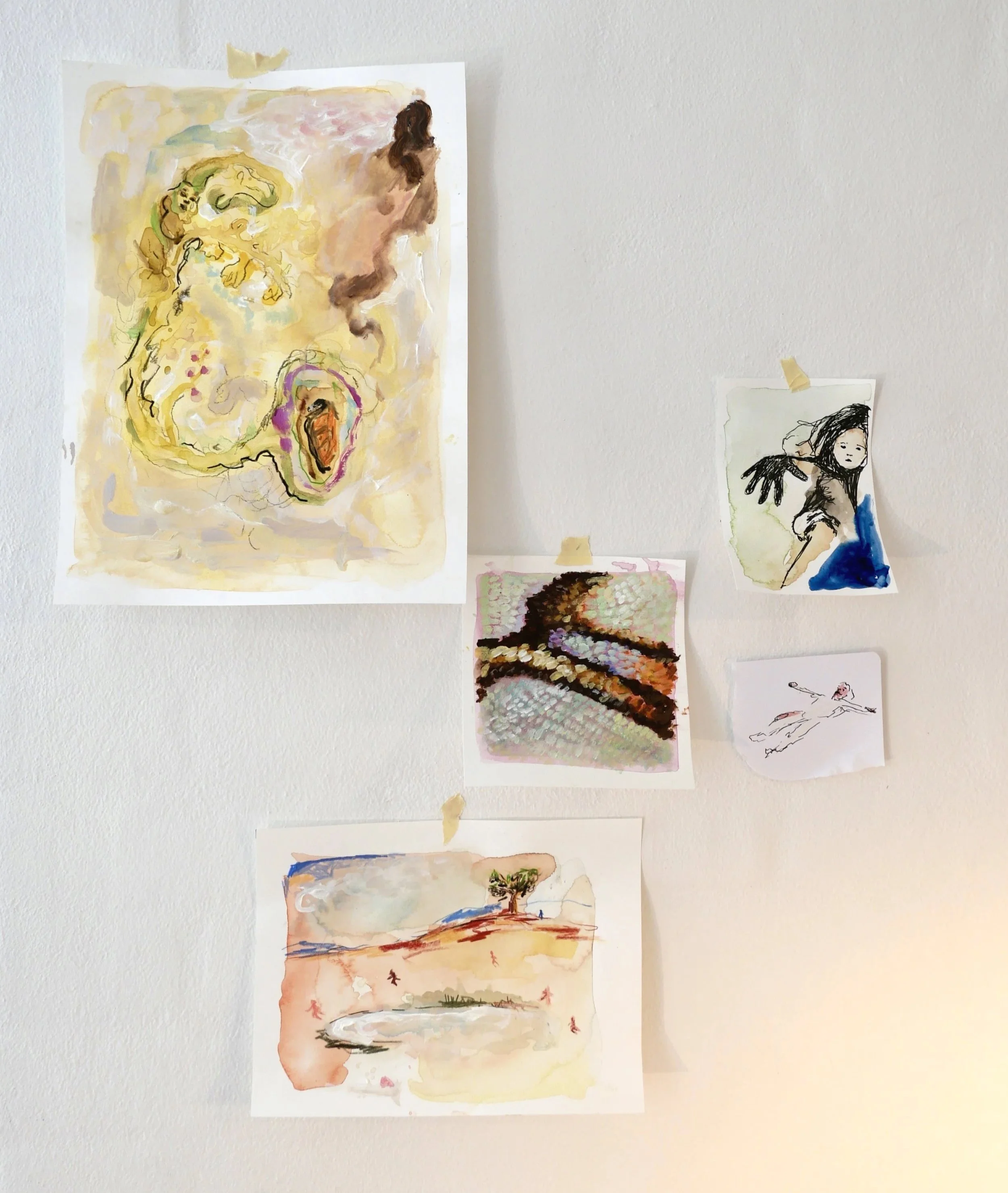 Multiple watercolor paintings of various landscapes and figures taped to a white wall.