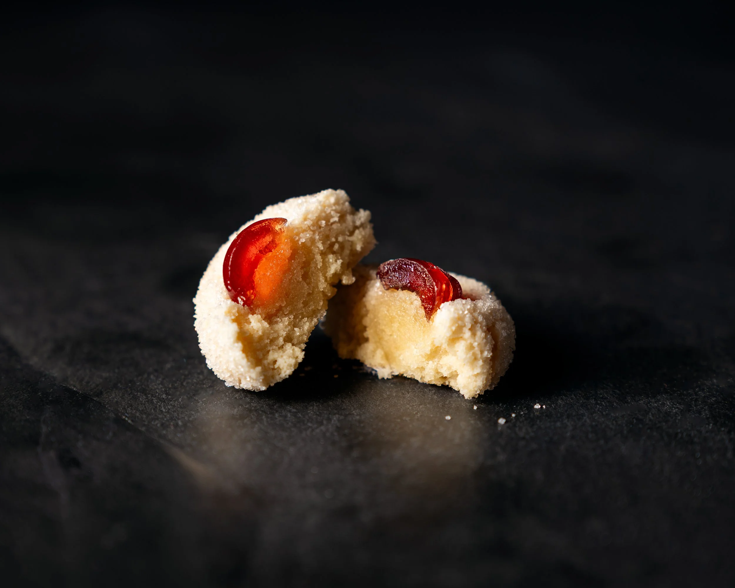 Amaretti Italian cake with glaciee cherry on top split open to show the crumb and texture inside.