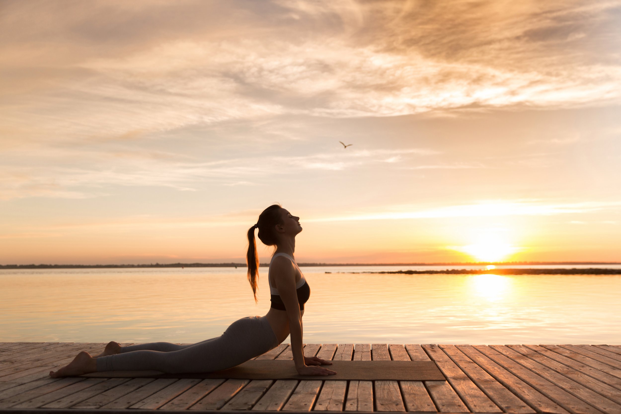 storyblocks-picture-of-attractive-young-sports-lady-at-the-beach-make-yoga-exercises_rRZ7hr2pcW.JPG