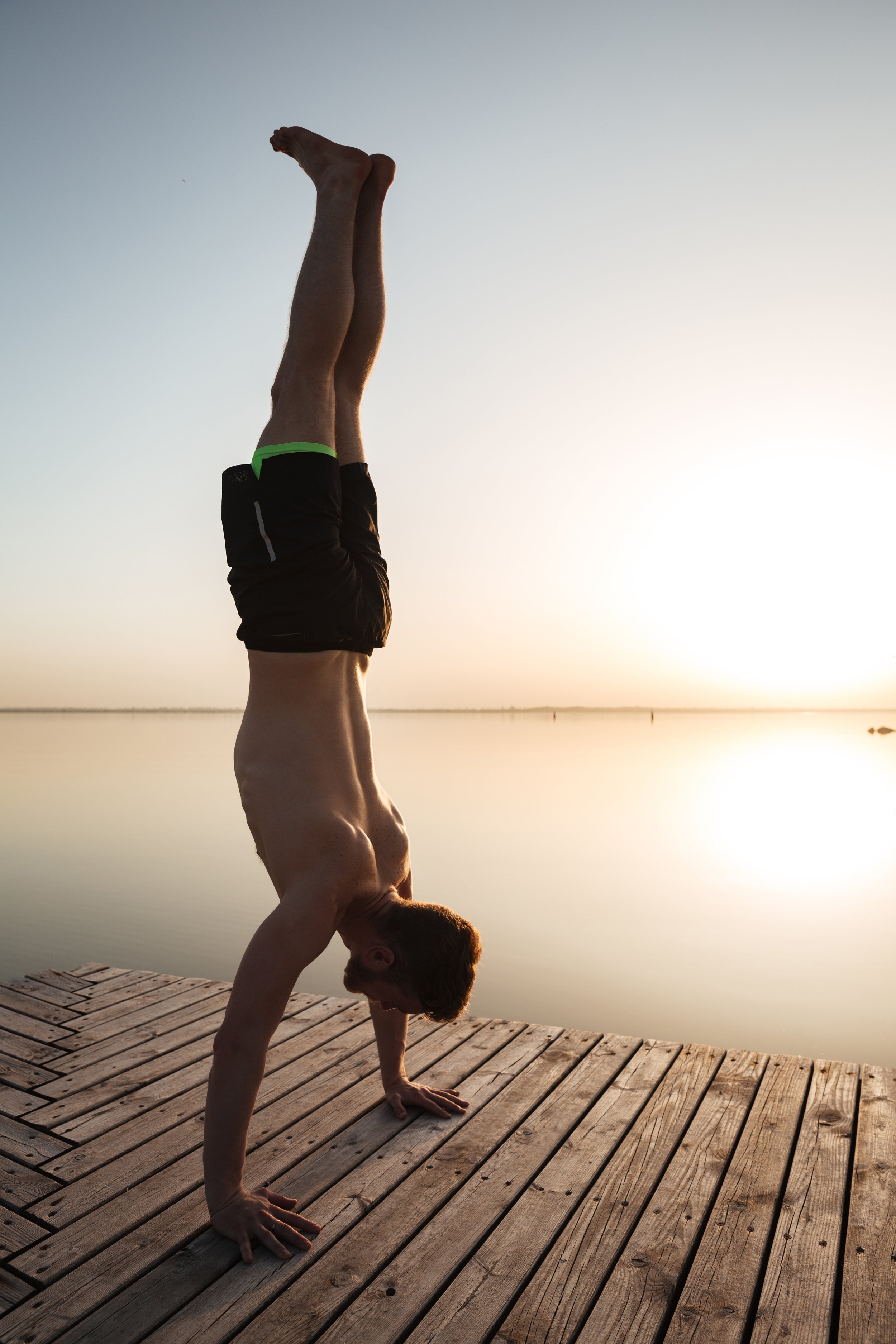 storyblocks-image-of-handsome-young-sportsman-make-yoga-exercises-at-the-beach_HRQ_hZ2pc-.JPG