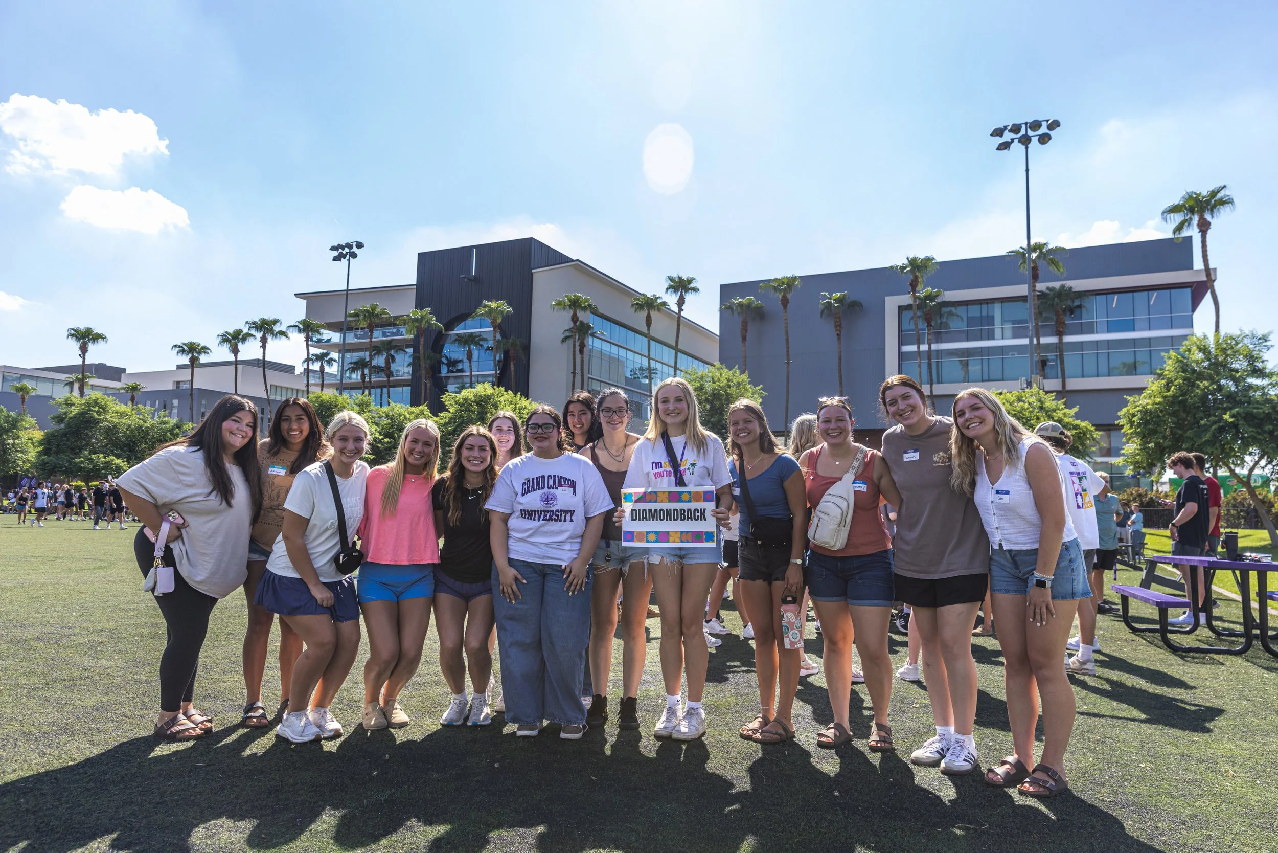 Grand Canyon University students gathering around in circle during their O-group breakout at Welcome Week.