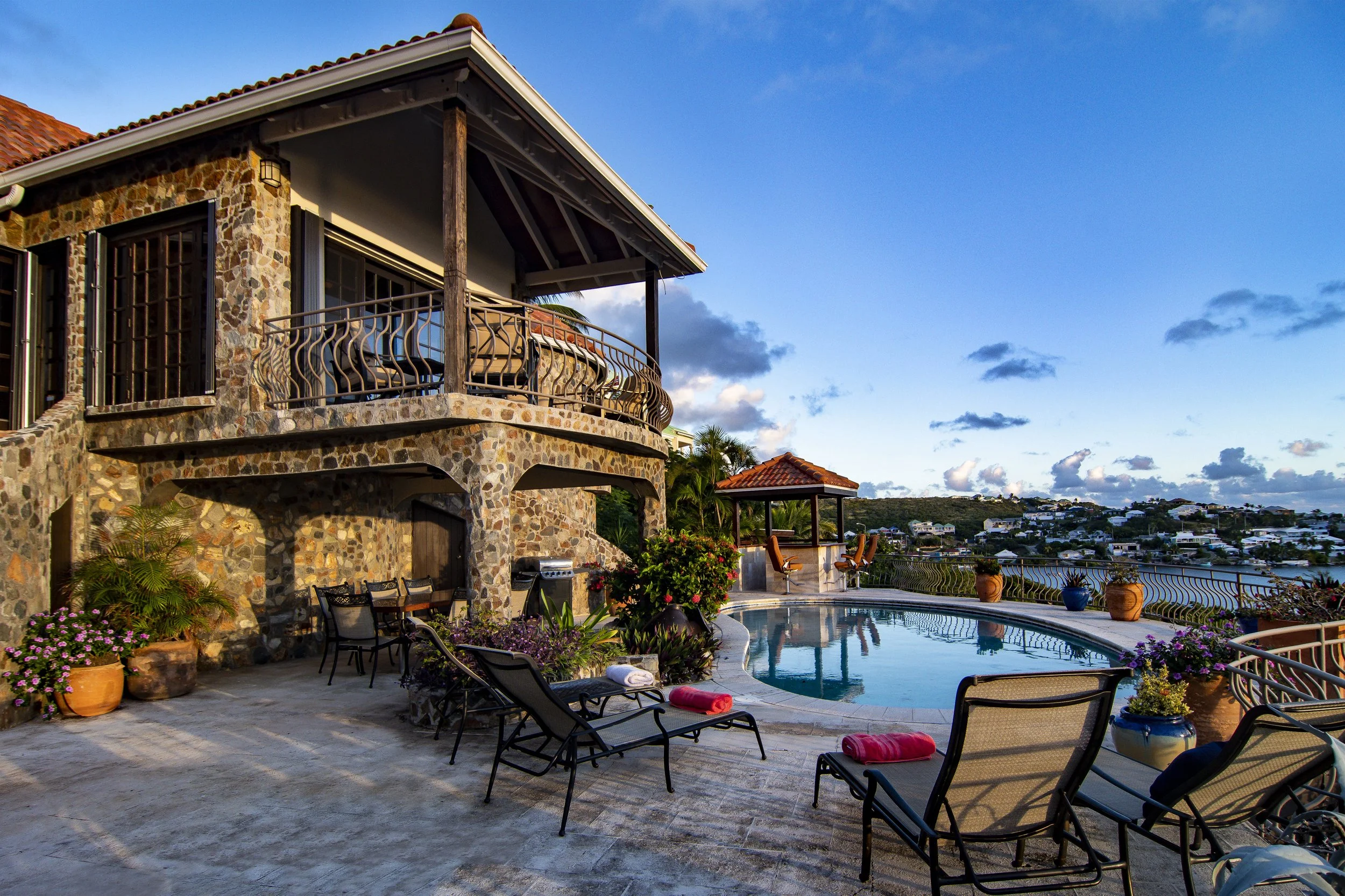 Tropical Home Infinity Pool over looking the mountains at Sunset 