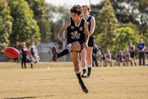 Inner-West-Magpies-boy-kicking-afl-ball-action-shot.jpg