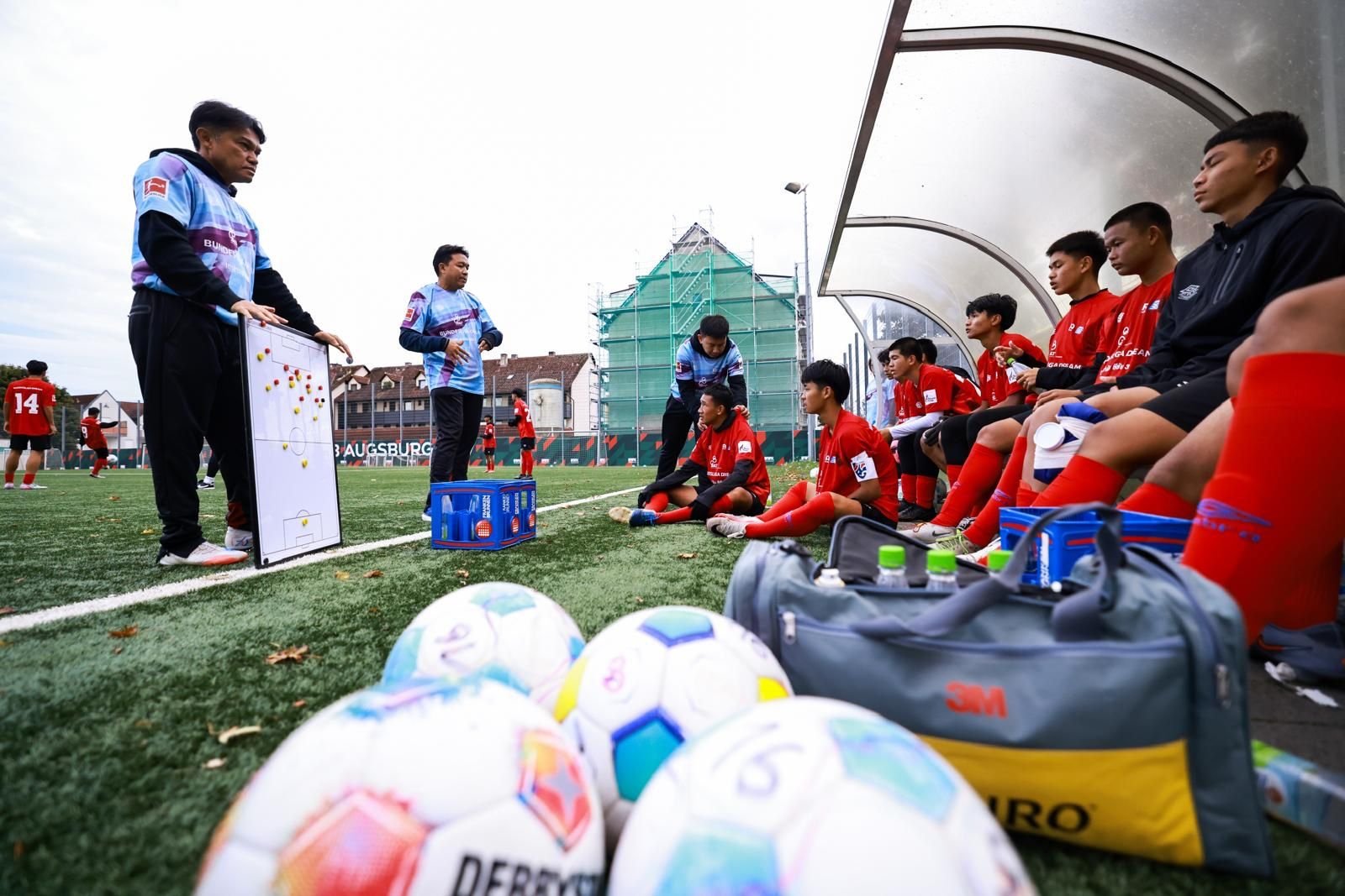 Bundesliga Dream Thailand players receiving team talk from coaches