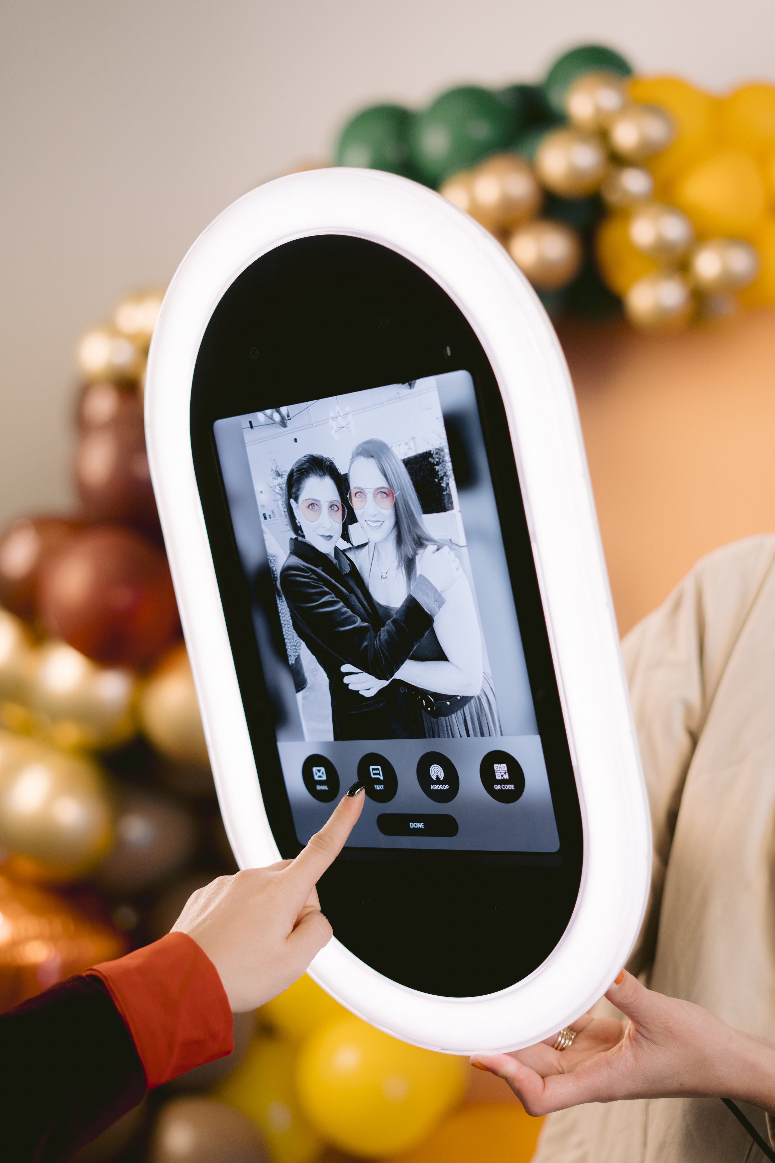 Guest viewing a black and white photo on the Opto Booth Go touchscreen