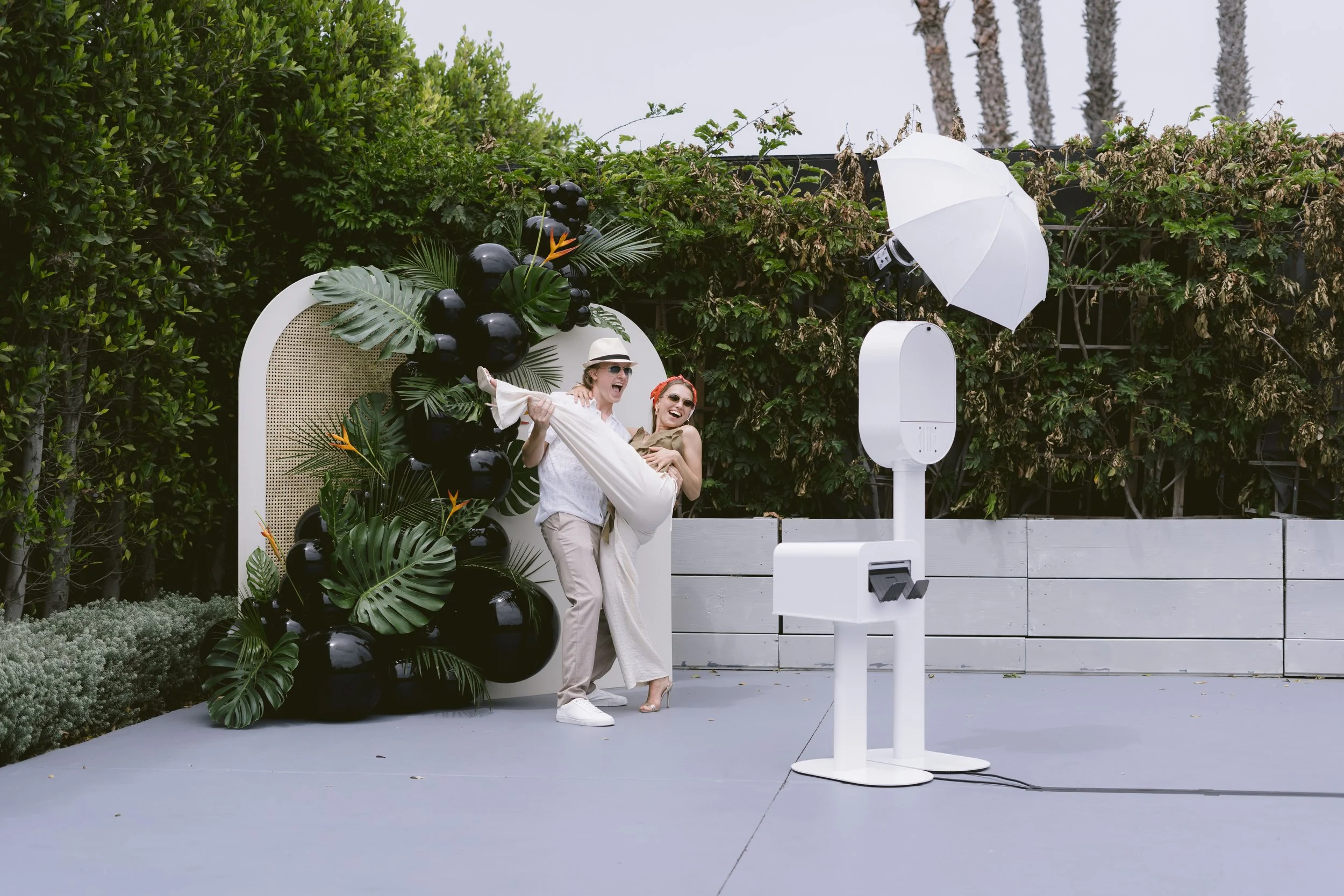 Opto Booth Go setup beside wedding florals and event decor