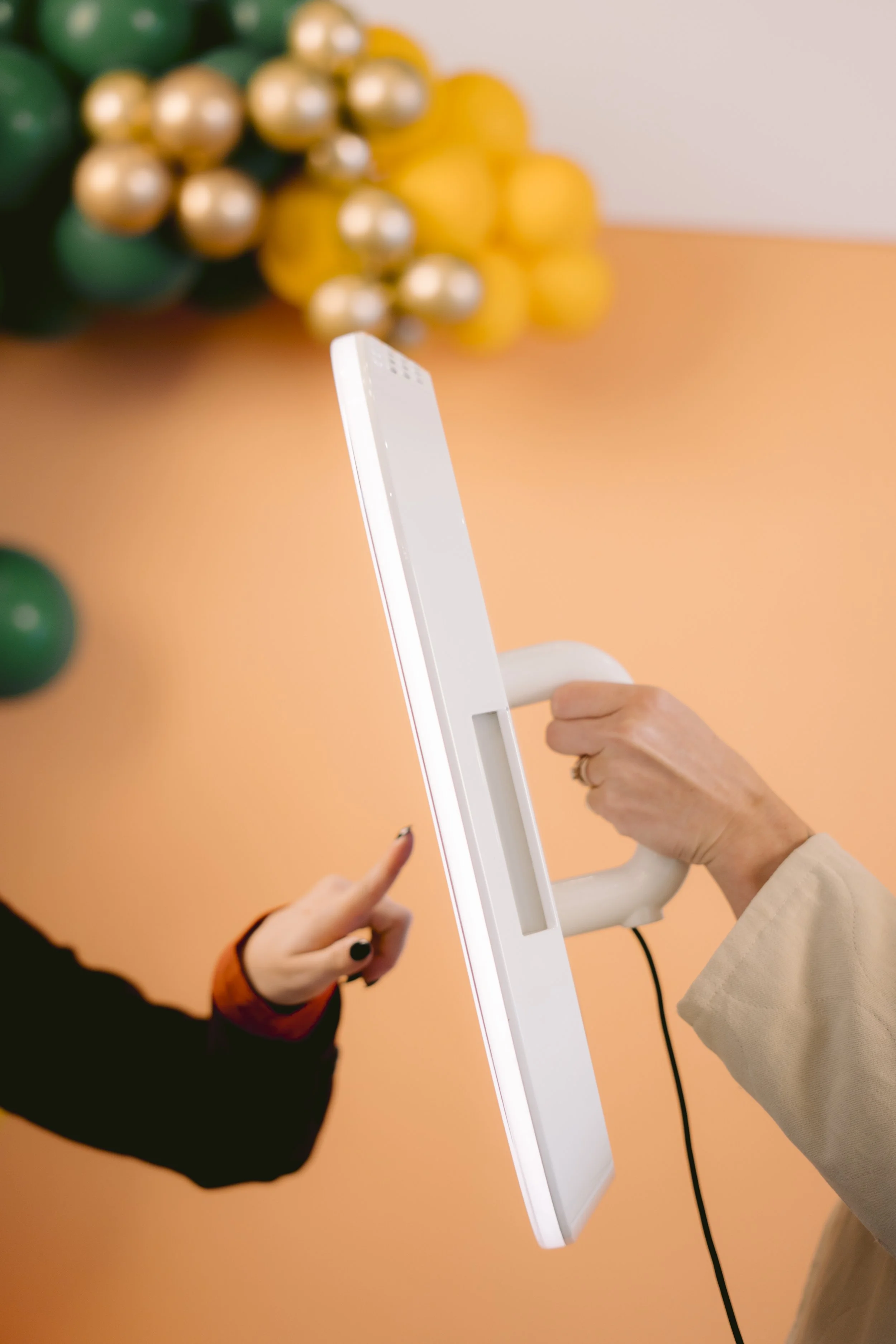 Close-up of a guest using the Opto Booth Go touchscreen interface