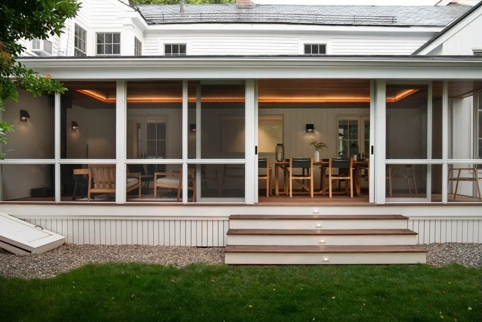 It could have been just another three-season porch.
A ceiling fan. A few surface fixtures. Bright enough, but forgettable.

Instead, the light looks like it belongs&mdash;tucked into the architecture, grazing warm wood, shaping the room without annou