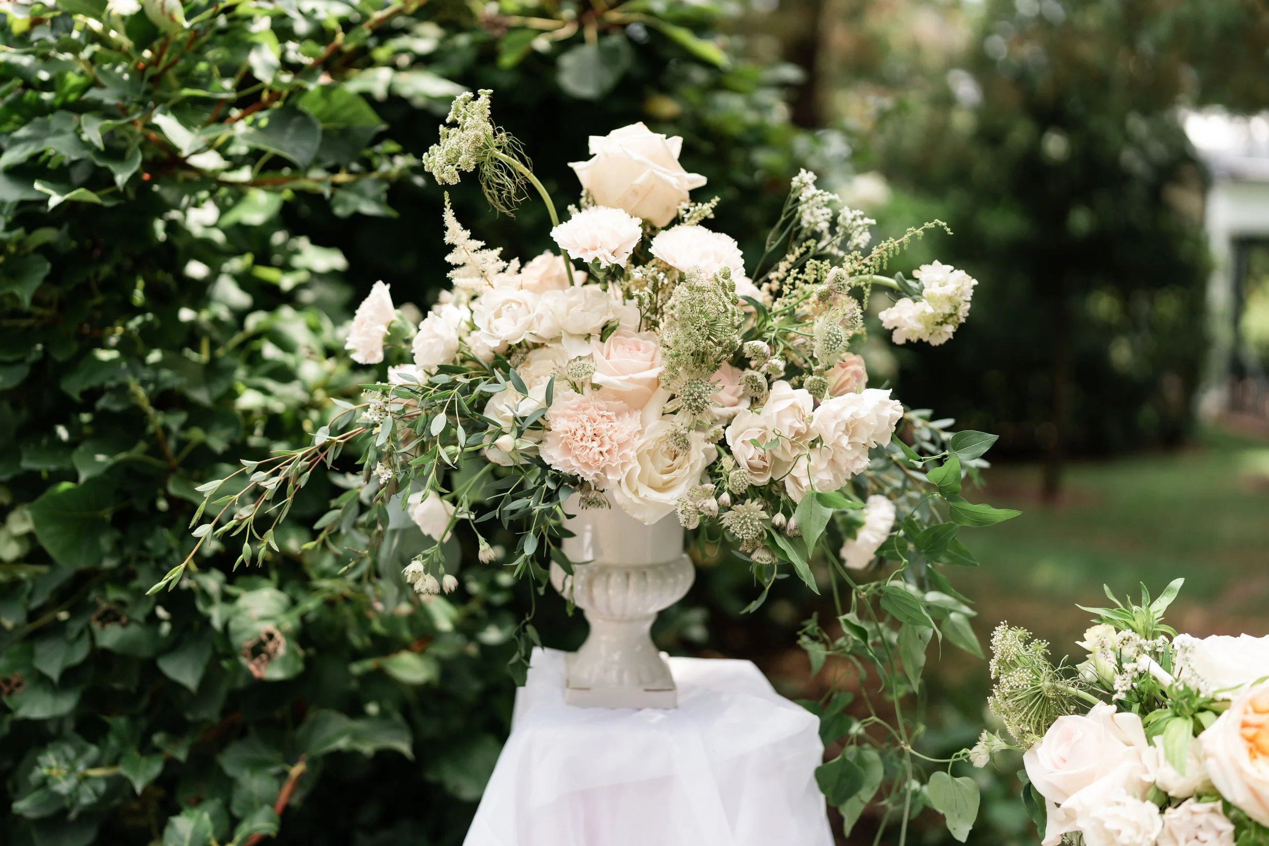 Classic greenery and white and blush pink light arrangement.