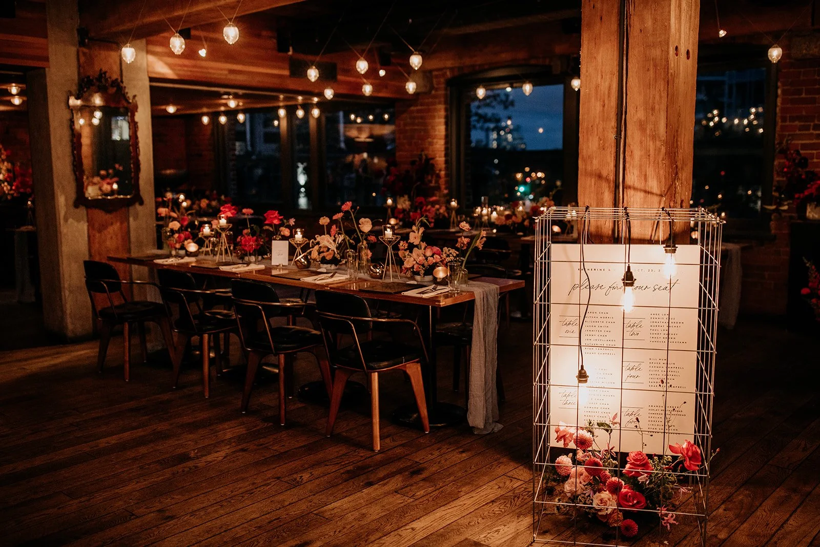 Moody wedding decor setup filled with bulb lights and colourful florals