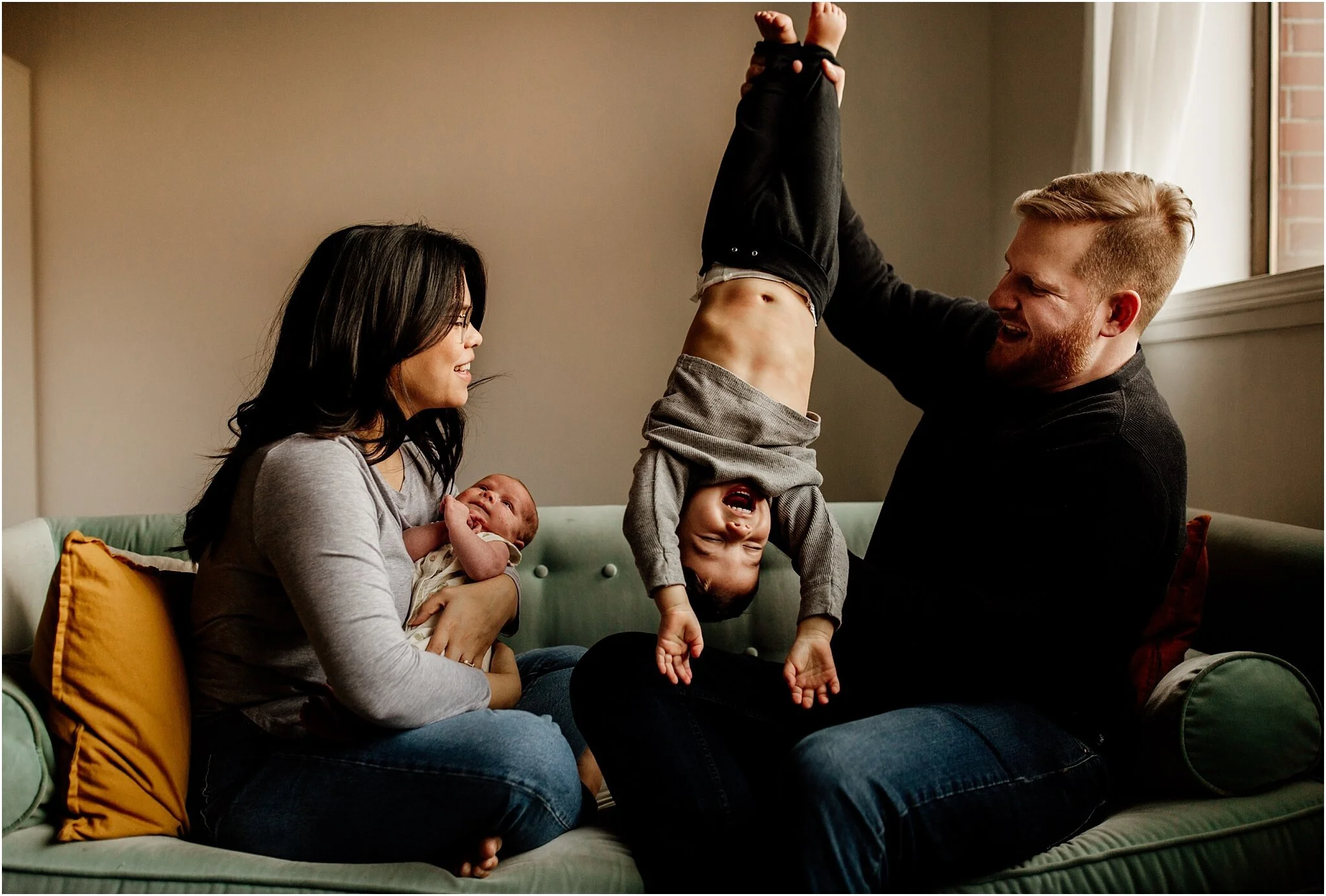 candid family studio portrait with a family of four in vancouver studio