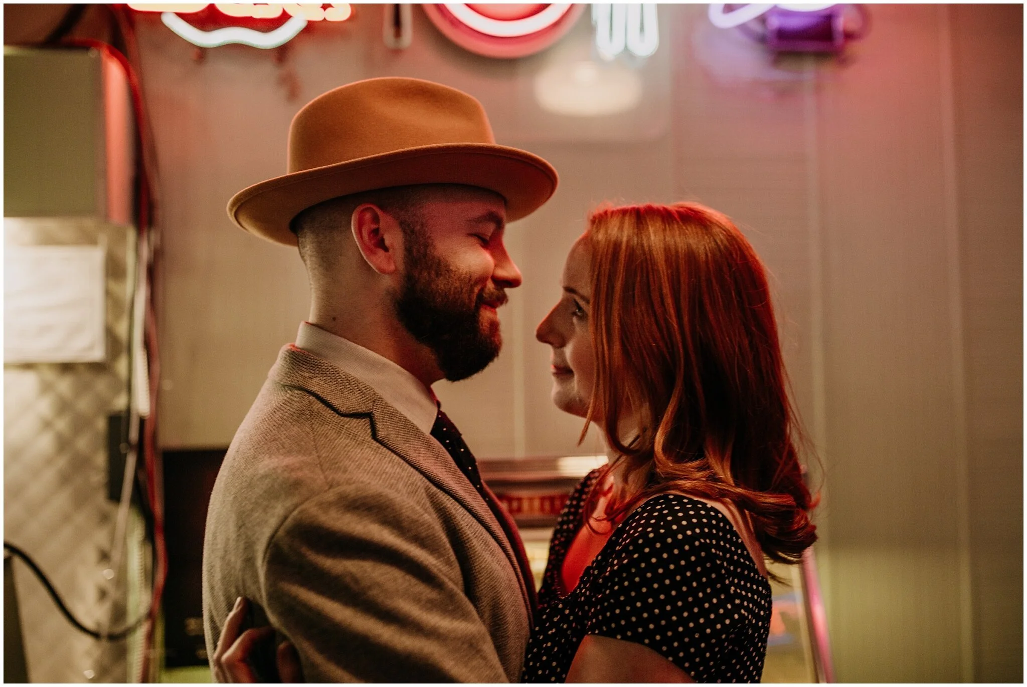 couple engagement photos with neon lights in the templeton