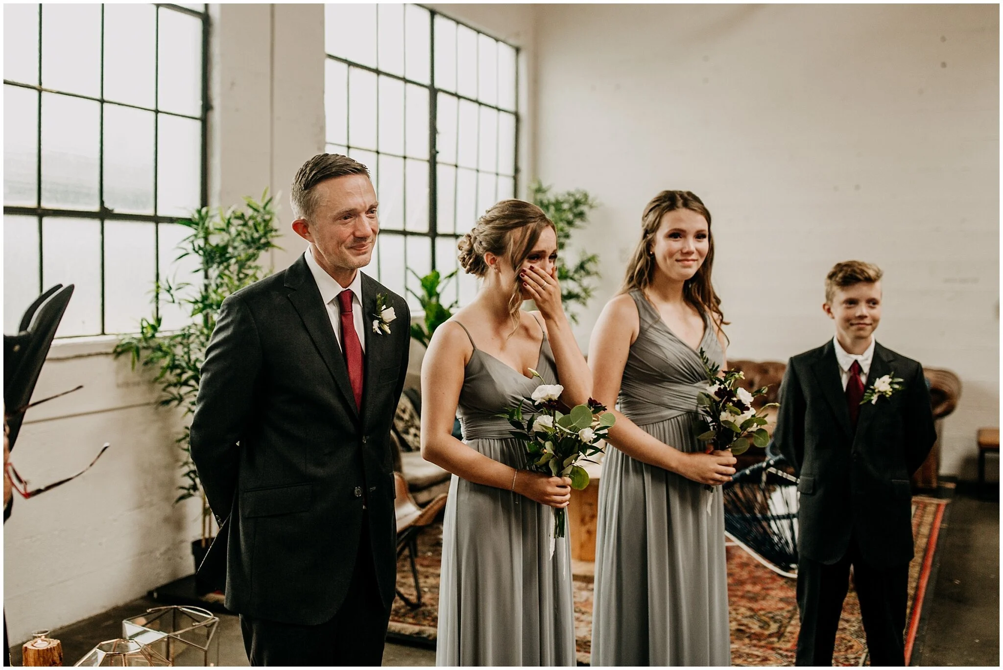 groom and daughter's reaction to bride walking down aisle at settlement building