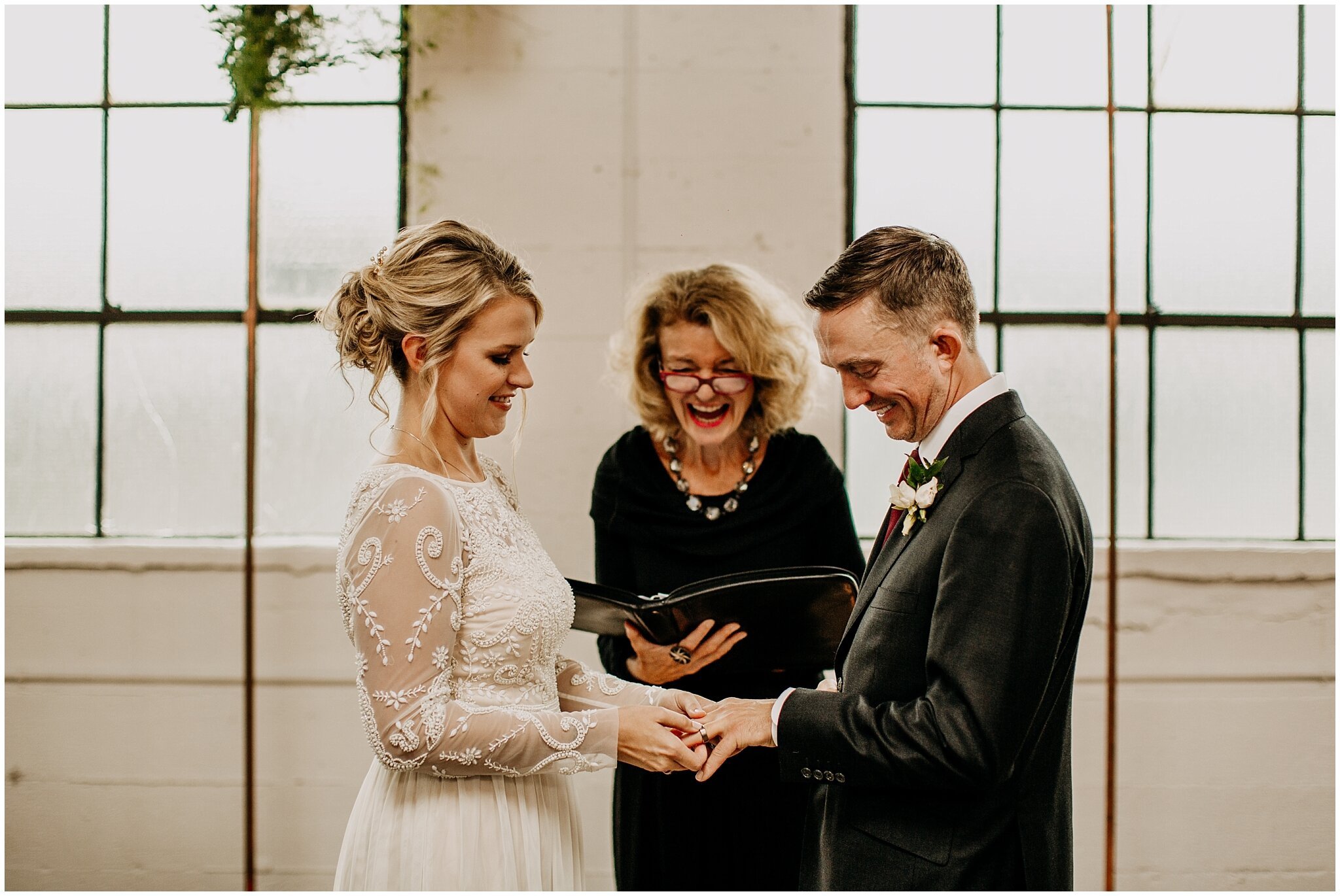bride and groom exchanging rings at settlement building wedding