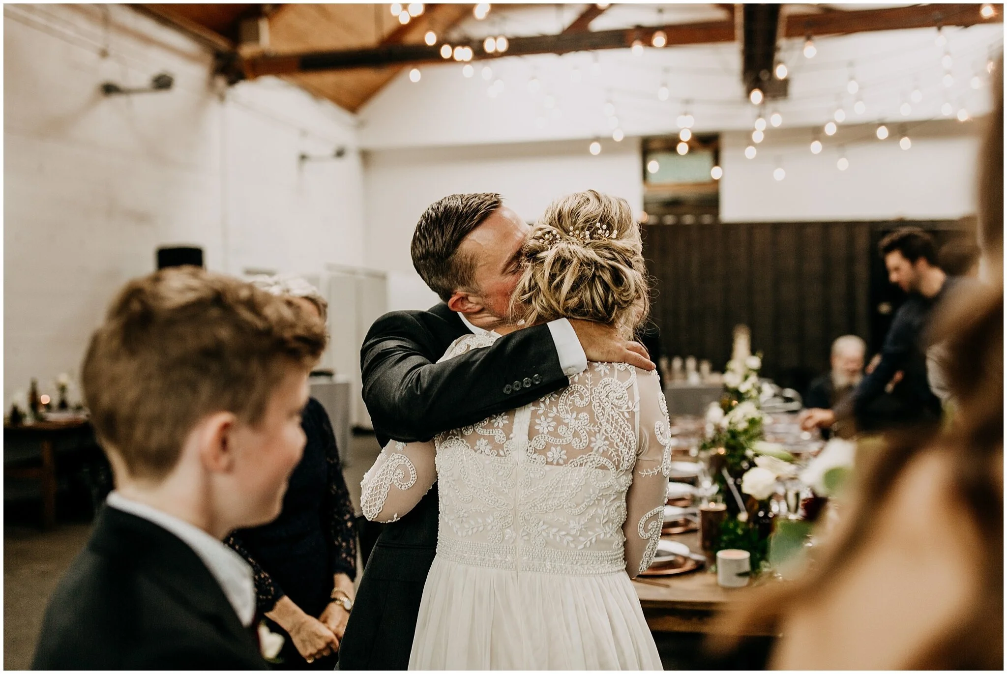groom kissing bride candid moment at settlement building wedding