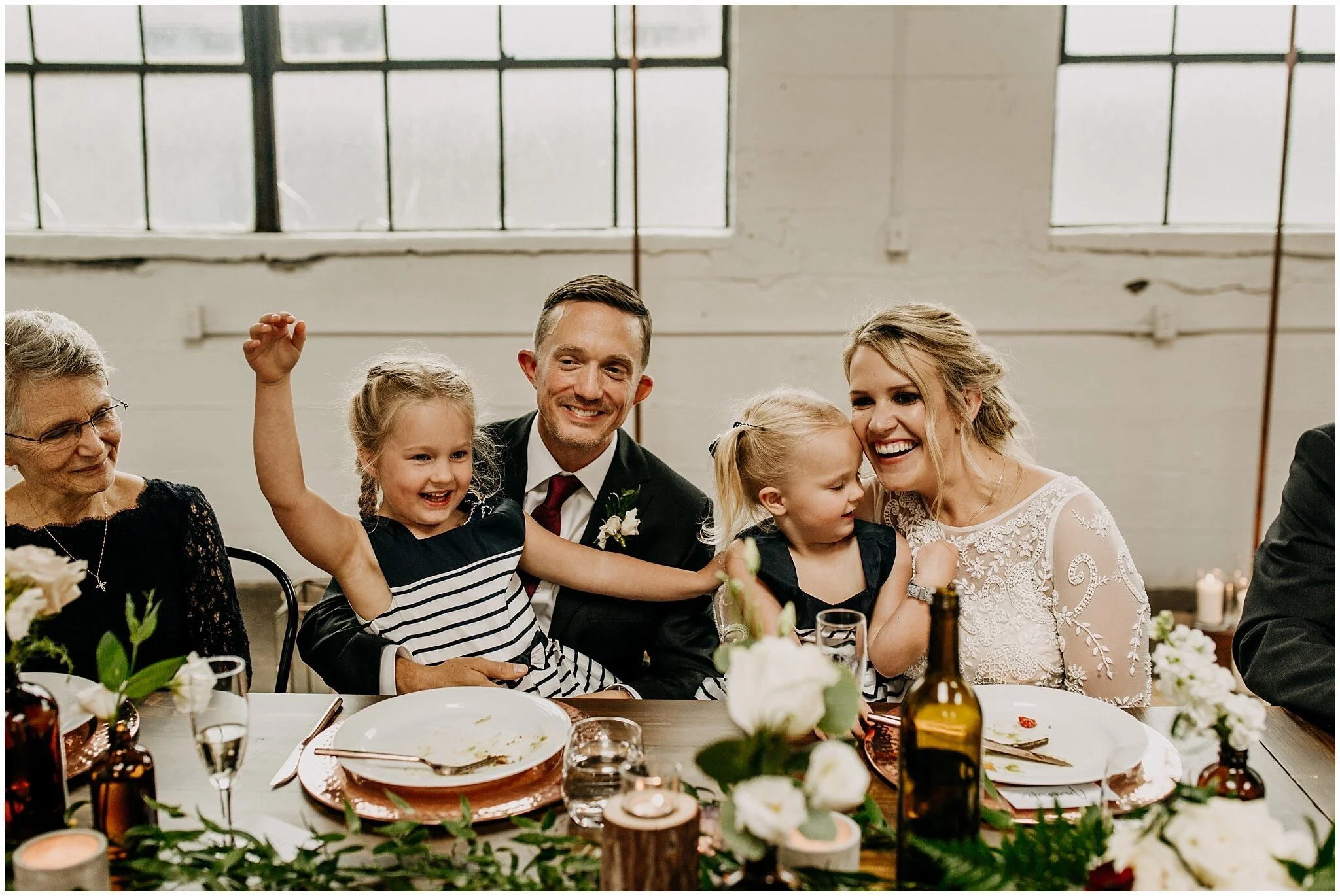 bride and groom candid moment with nieces at settlement building wedding