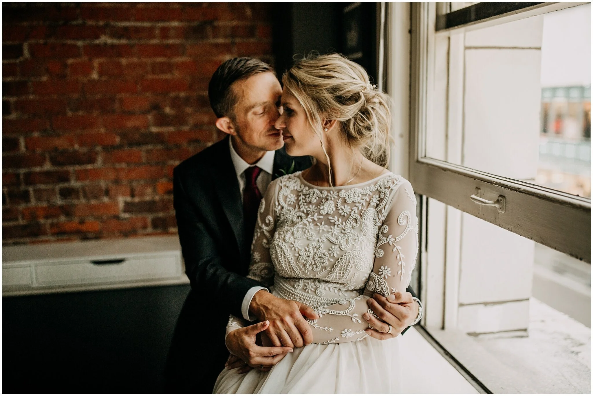 bride and groom window light portrait in vancouver block building 