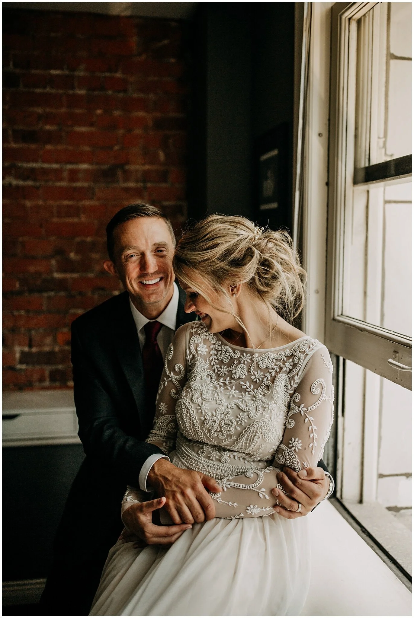 bride and groom window light portrait in vancouver block building