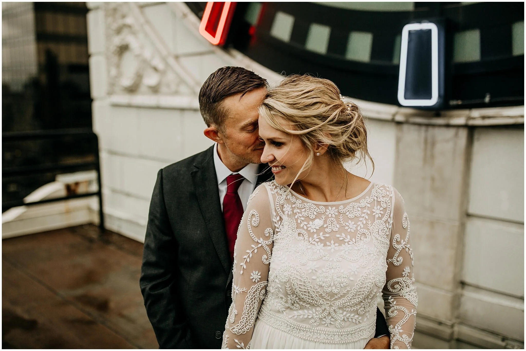 bride and groom portrait in front of clock tower in vancouver block