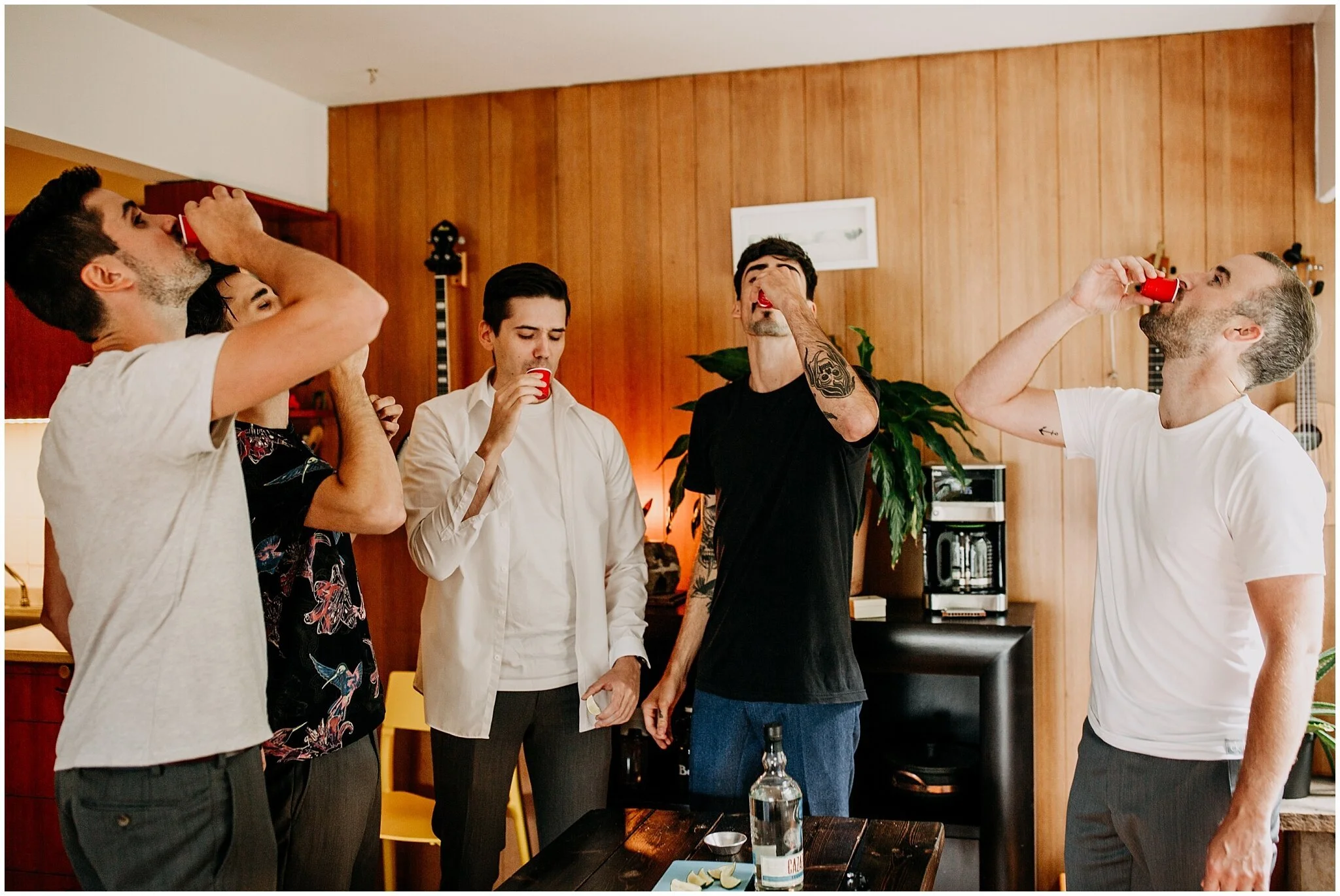 groomsmen and groom taking shots before ellis building wedding