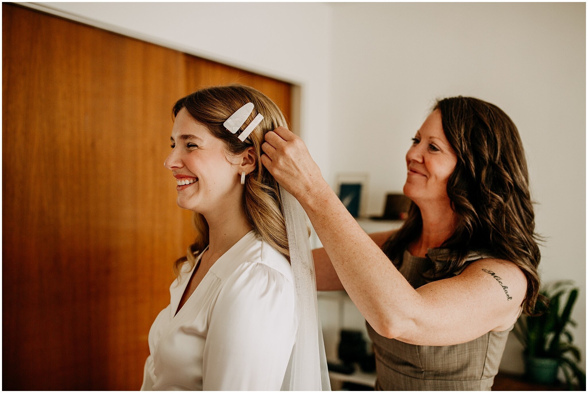 bride's mom putting veil on bride at ellis building wedding