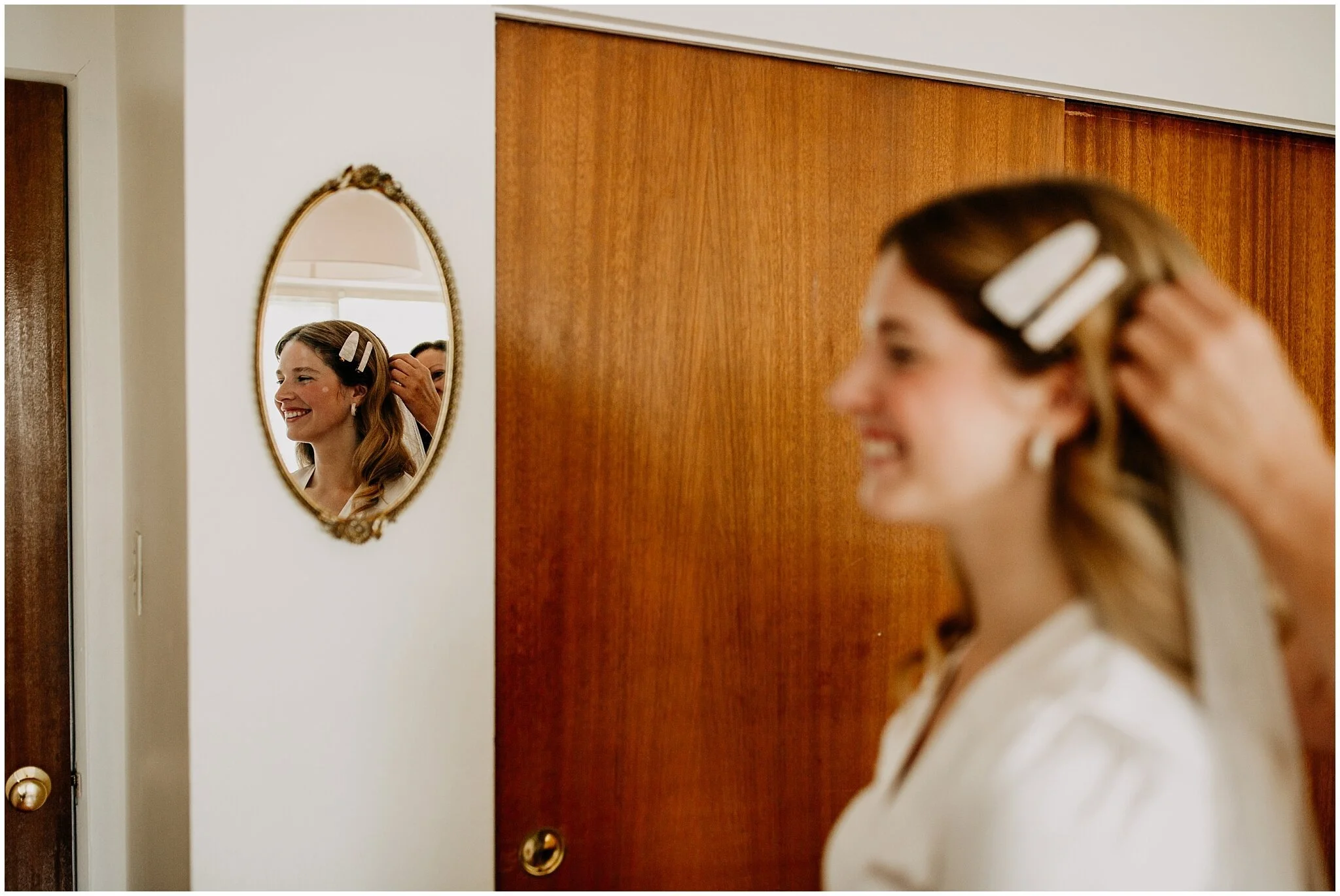 bride's mother putting veil on bride at ellis building wedding