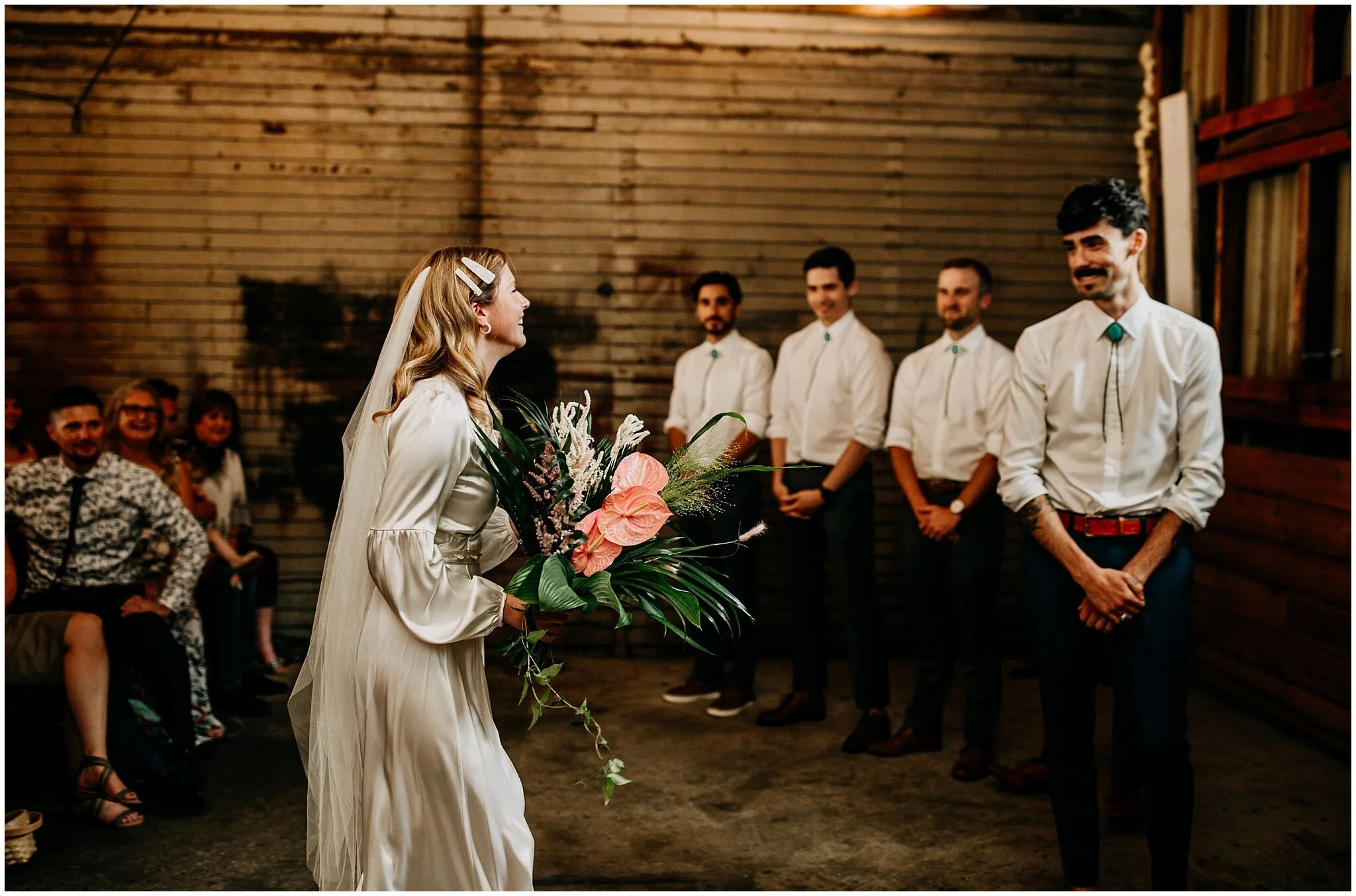 groom and bride seeing each other at ceremony at ellis building