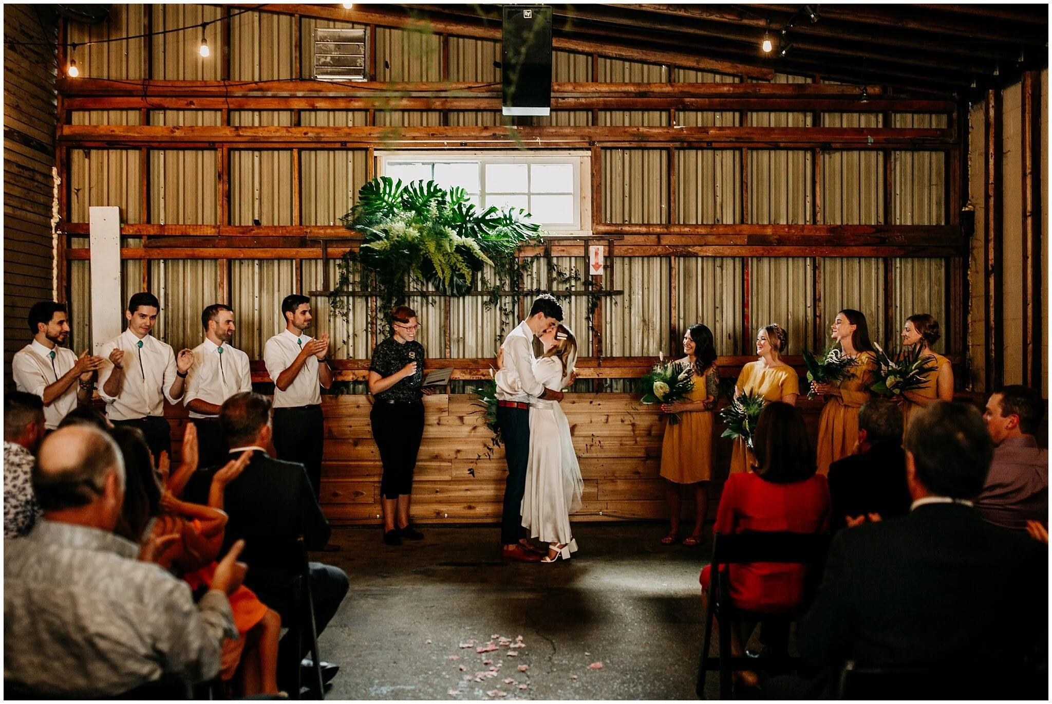 bride and groom first kiss at ellis building wedding