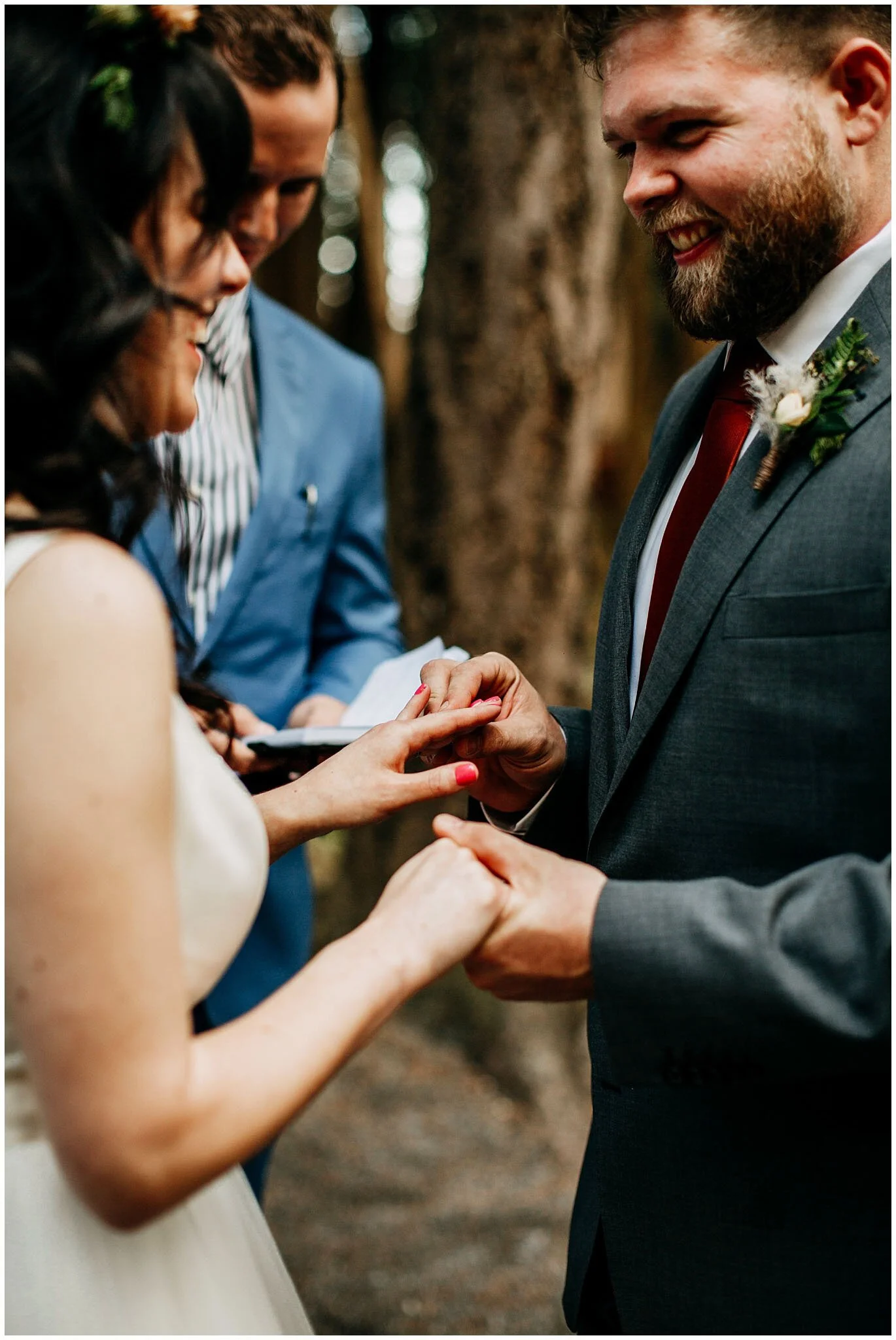 groom putting ring on bride's finger sea cider farm and ciderhouse wedding