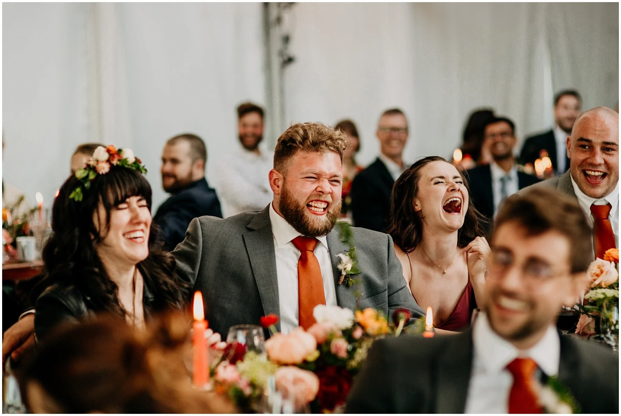 bride and groom laughing candid during speech at sea cider farm and ciderhouse wedding