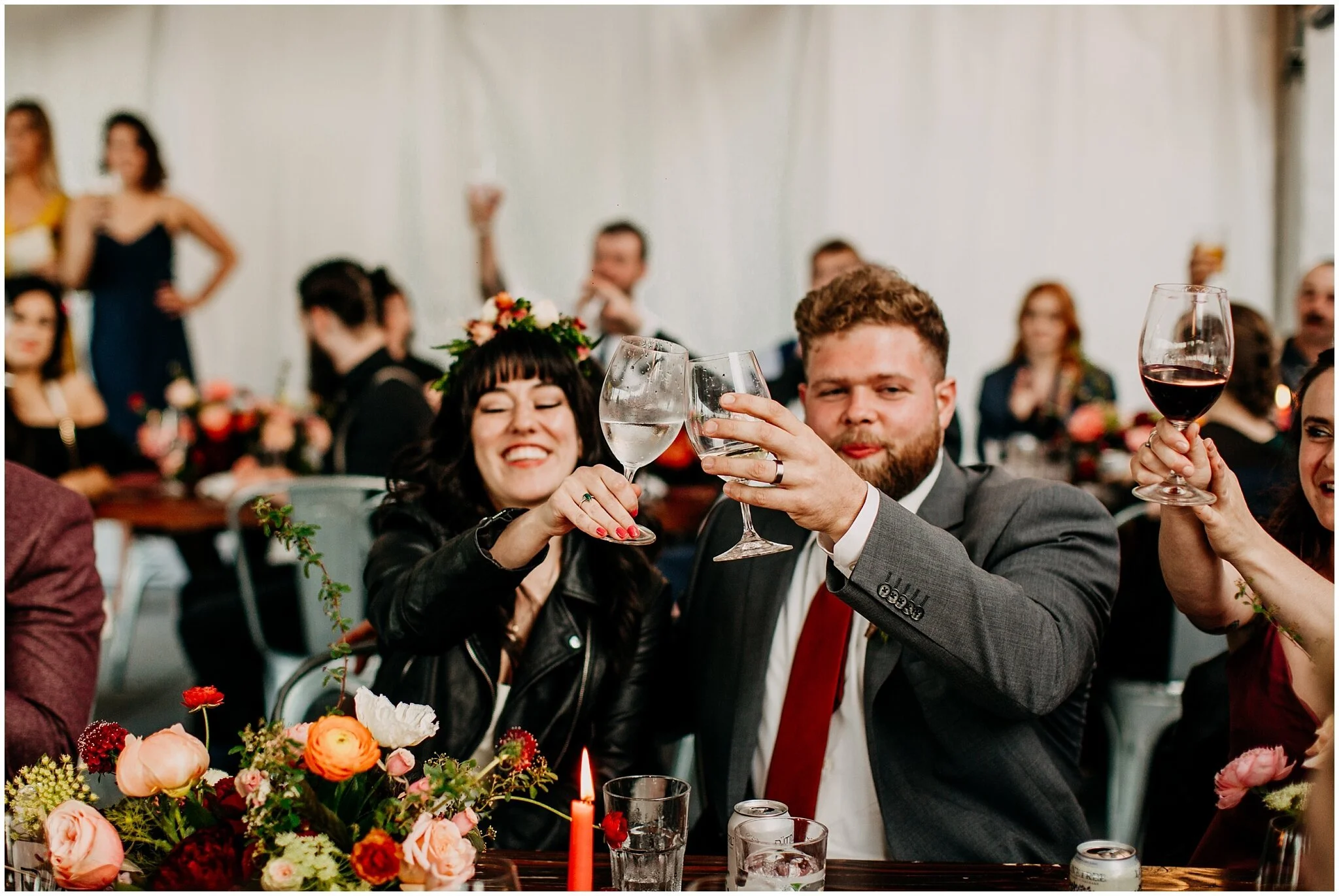bride and groom cheers at sea cider farm and ciderhouse wedding reception