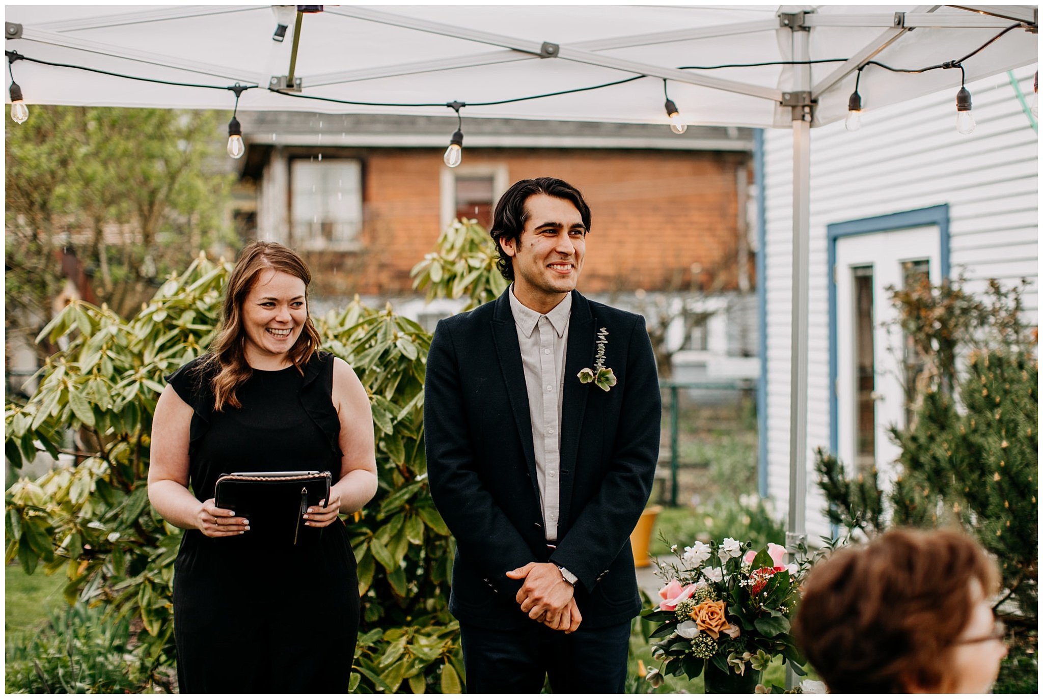 groom watching bride walk down aisle in vancouver backyard elopement