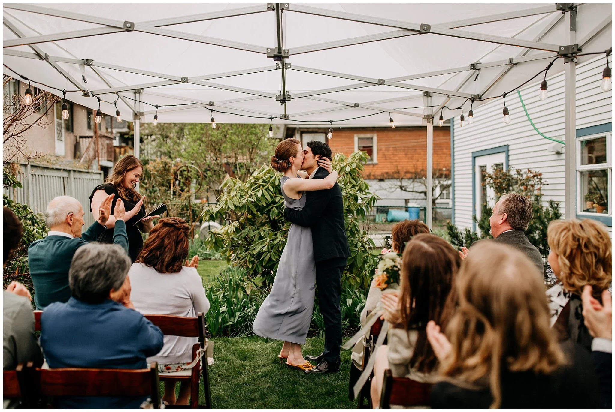 bride and groom first kiss at vancouver backyard elopement
