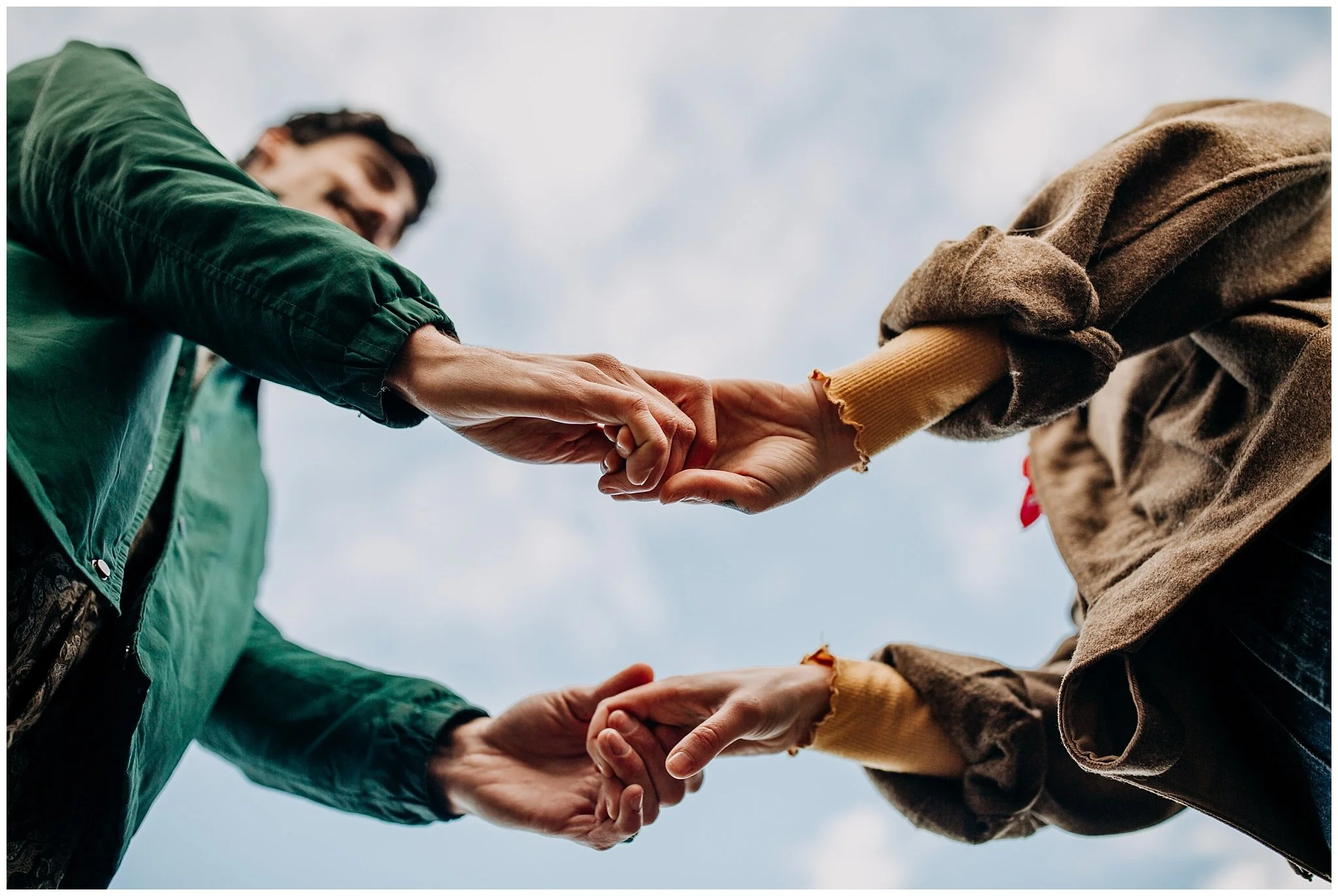 creative perspective of couple holding hands at jericho beach engagement session