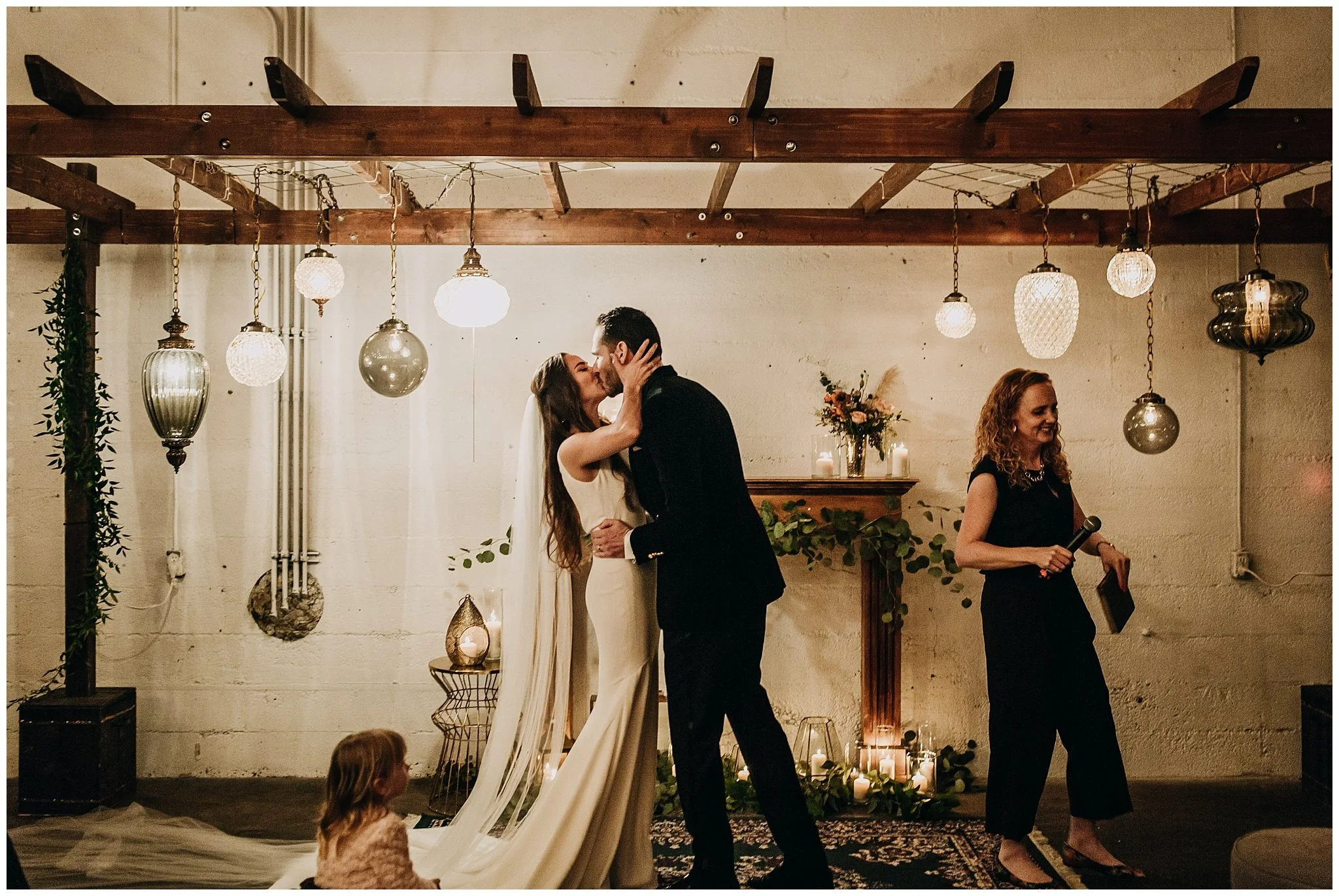 bride and groom first kiss at settlement building wedding