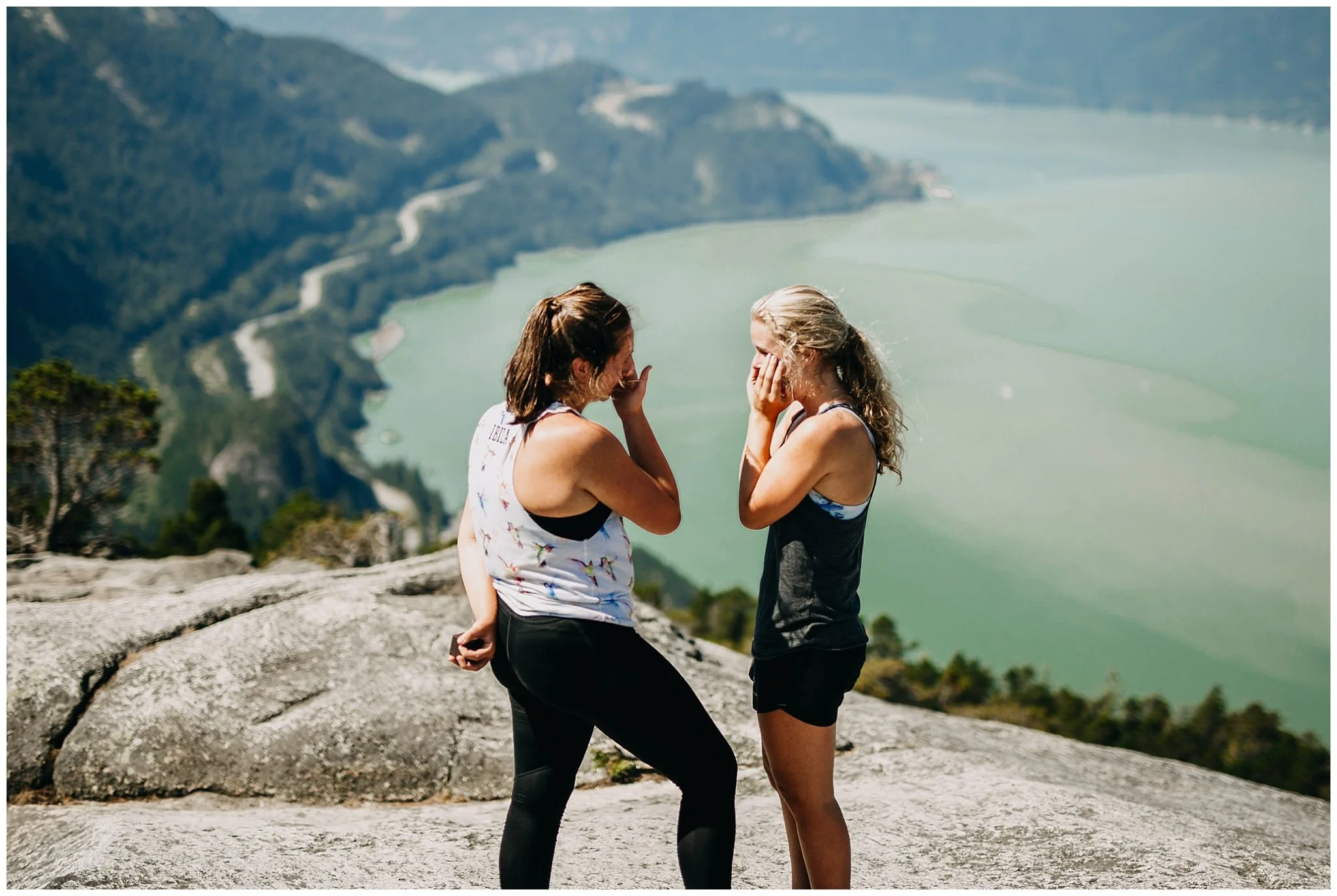 same sex couple crying during proposal on the chief hike peak 