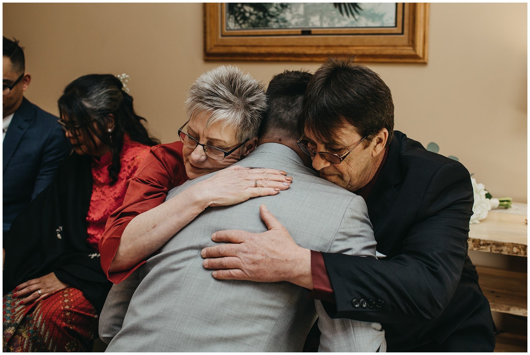 groom hugging parents emotional moment at fraser river lodge wedding
