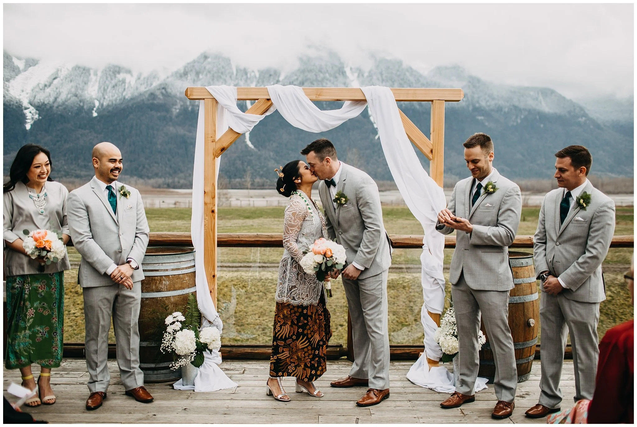 bride and groom first kiss at fraser river lodge wedding outside