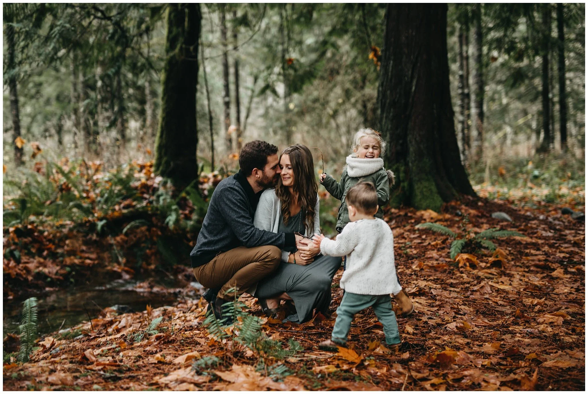 mom and dad snuggle kids playing around them chilliwack family photos