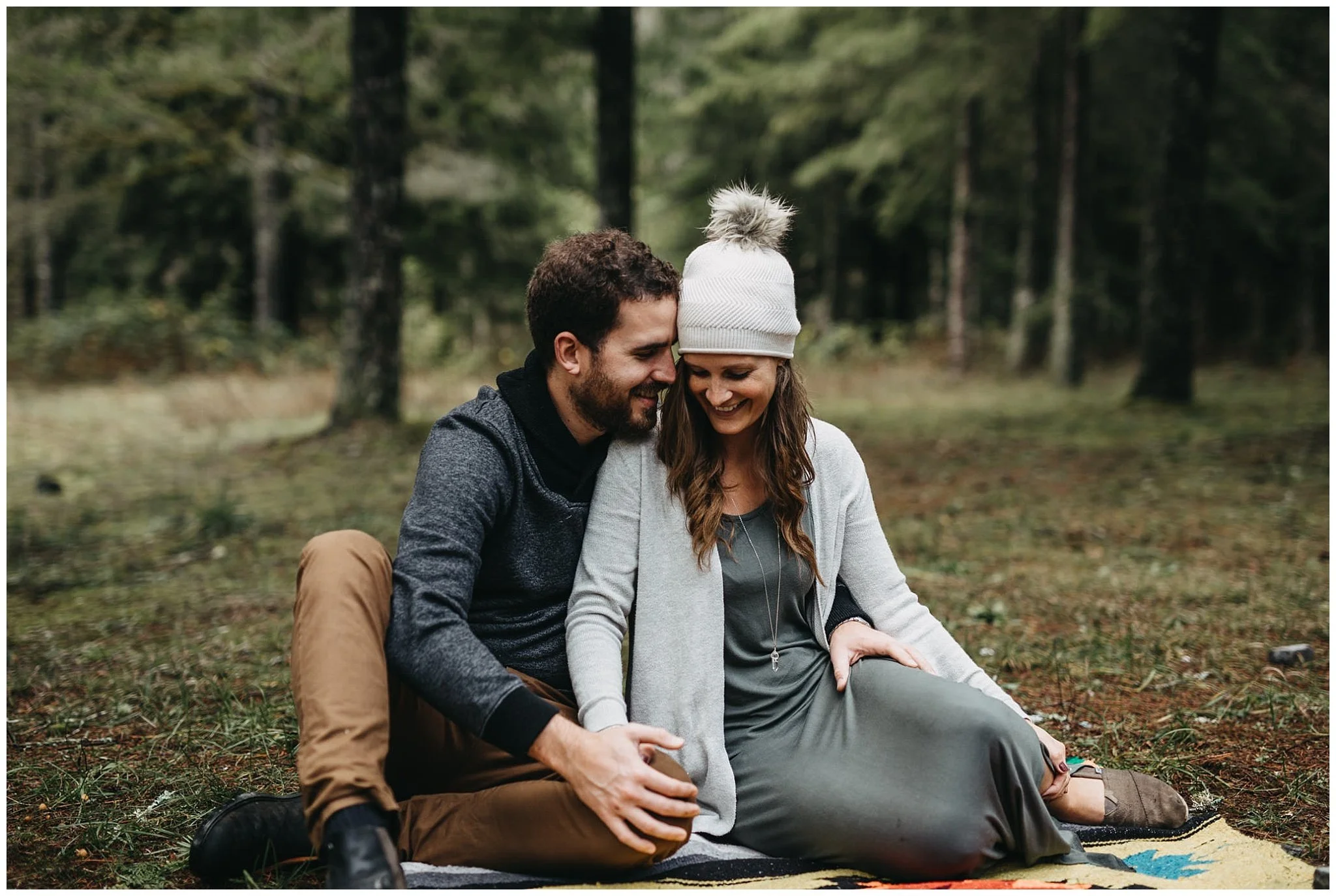 couple sitting on blanket family photos chilliwack forest