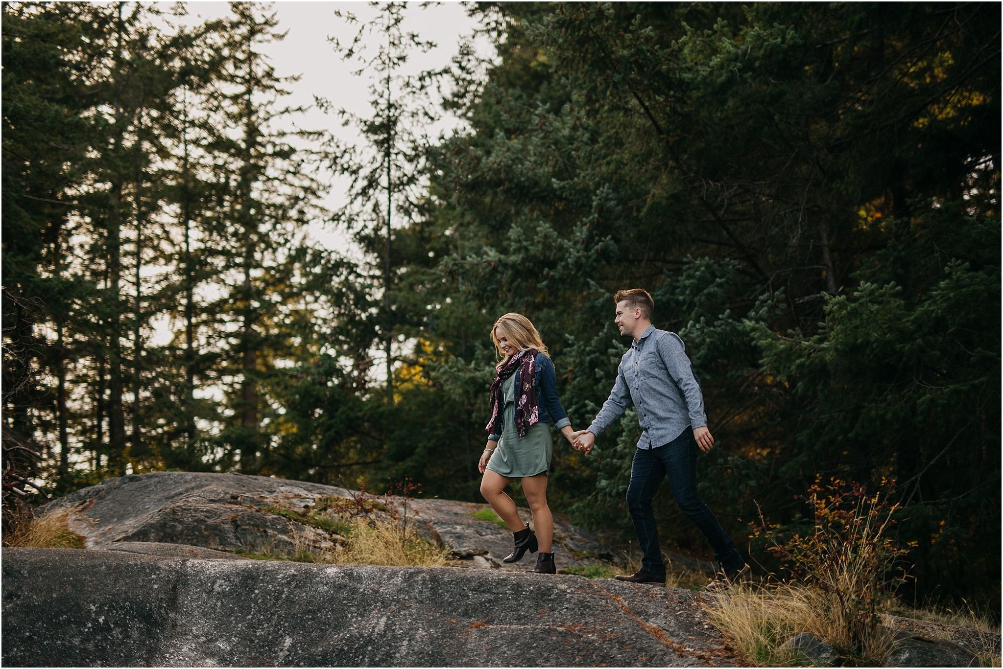 girl leading guy walking in forest