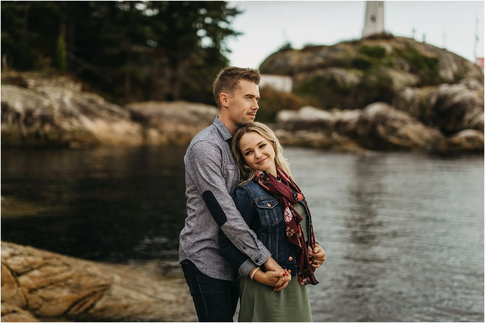 couple smiling holding hands close together ocean