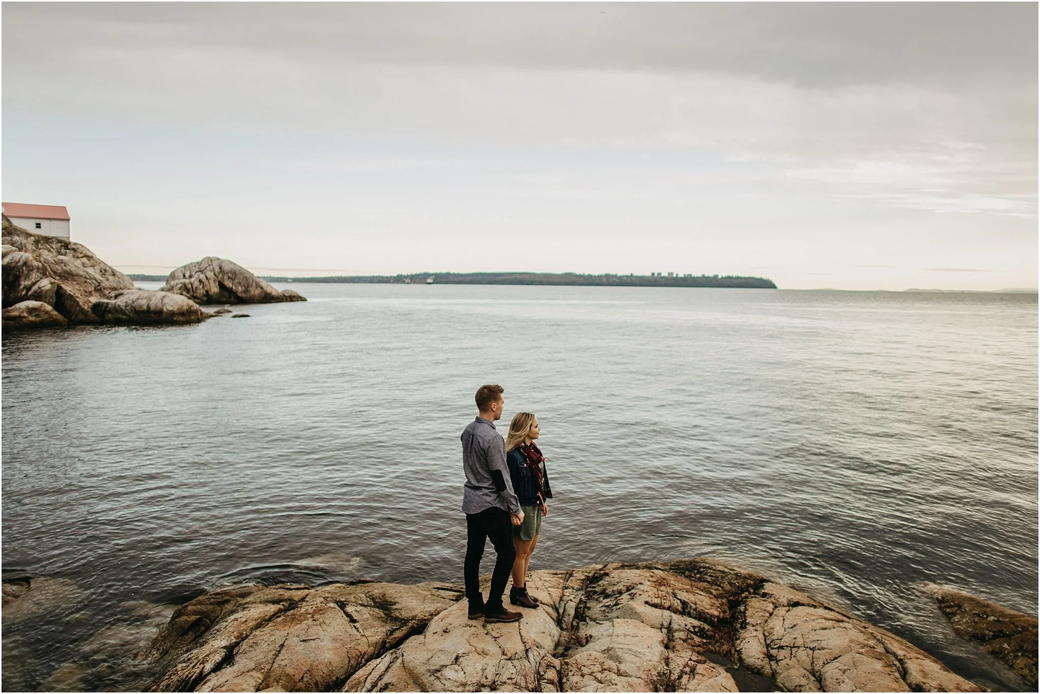 couple looking out at ocean at lighthouse park
