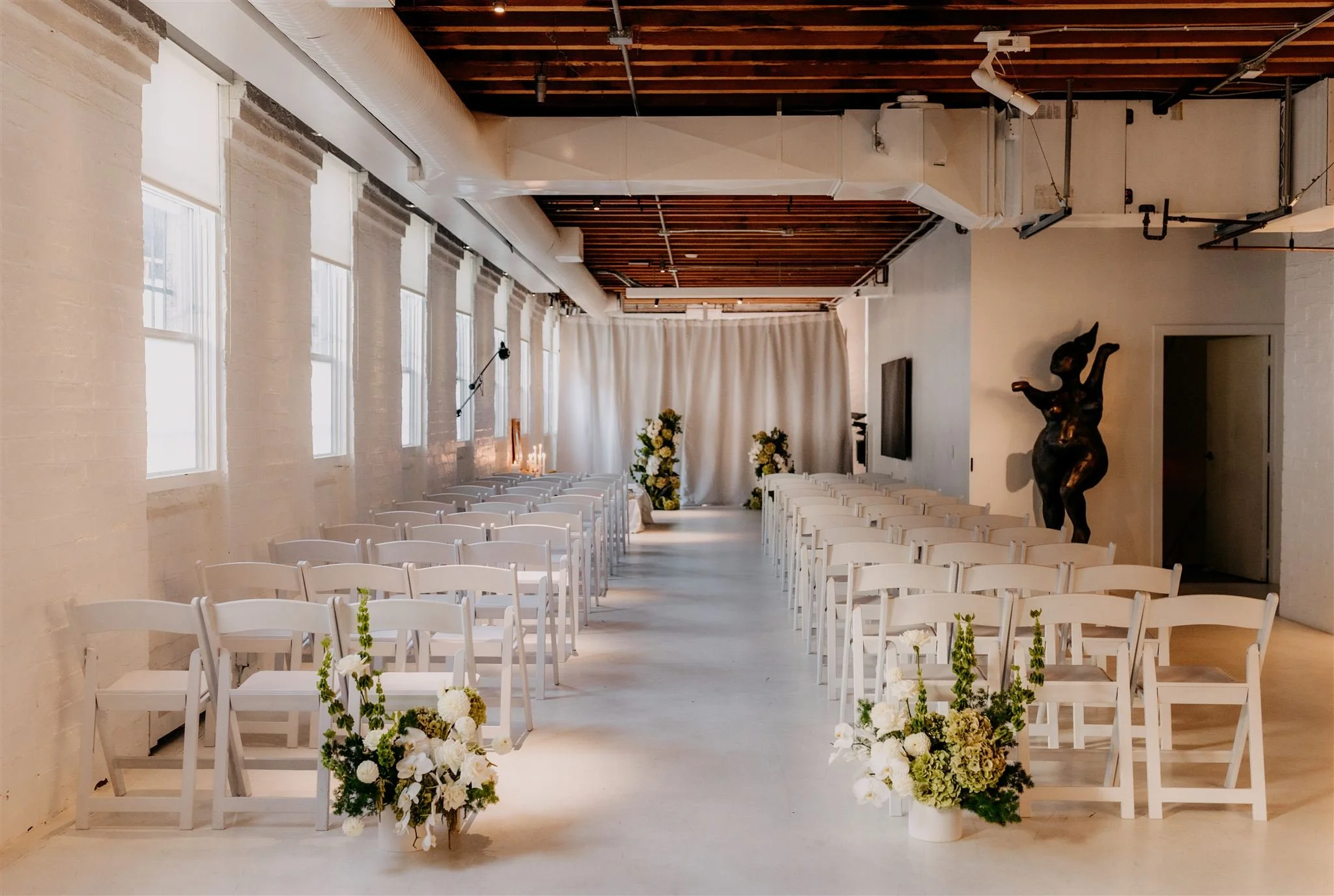modern and bright wedding ceremony decor with white and green flowers at the Kent in Vancouver