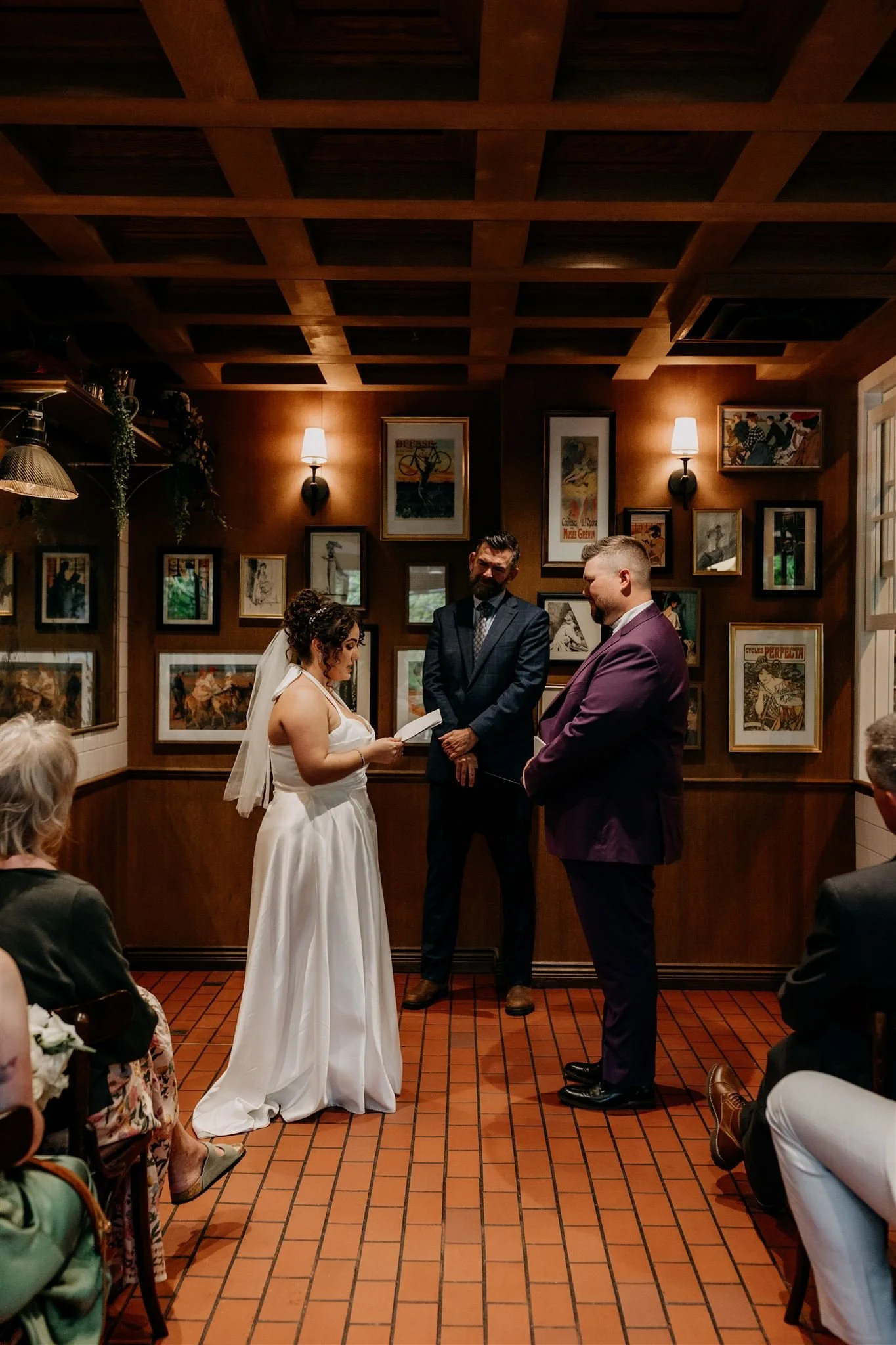 bride reading her vows during wedding ceremony inside Maxine's Cafe and Bar