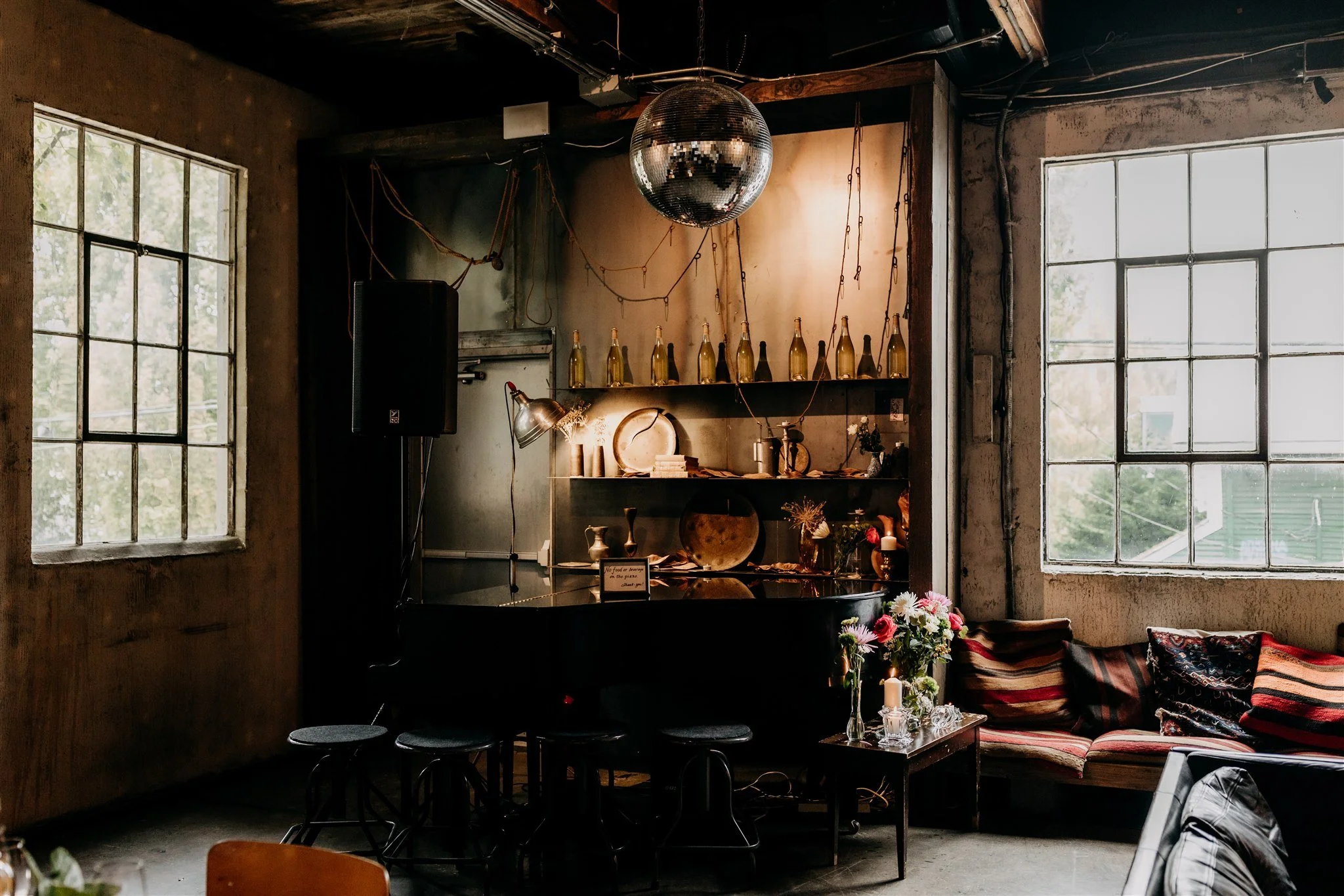 moody interior shot of La Fabrique St George with disco ball, mood lighting and piano