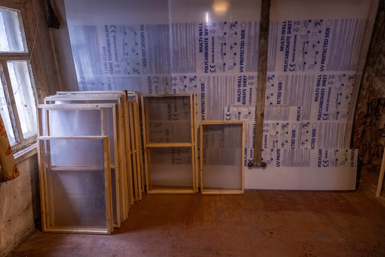 Completed Emergency Window V2 units and PET sheets prepared for installation