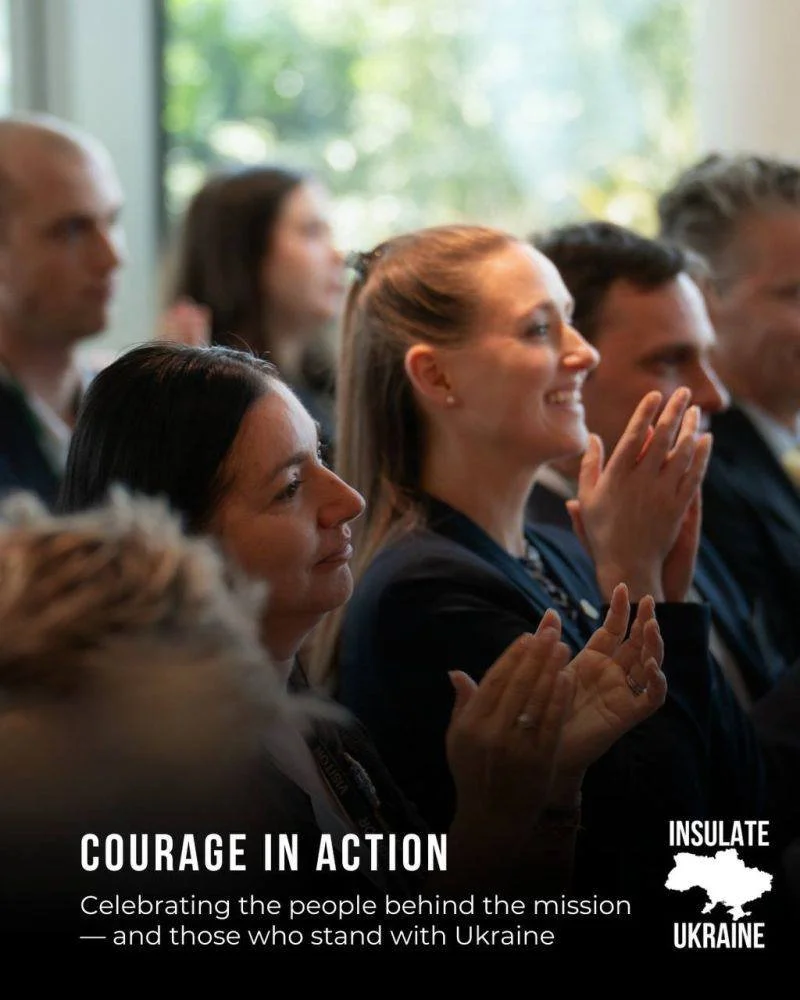 Audience members applauding during the event