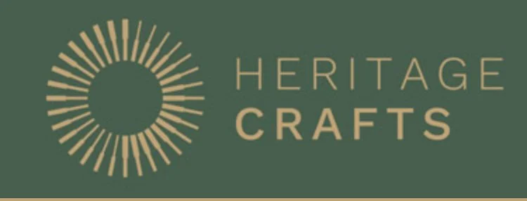 Heritage Crafts logo with a circular sunburst design and the text 'HERITAGE CRAFTS' on a dark green background.